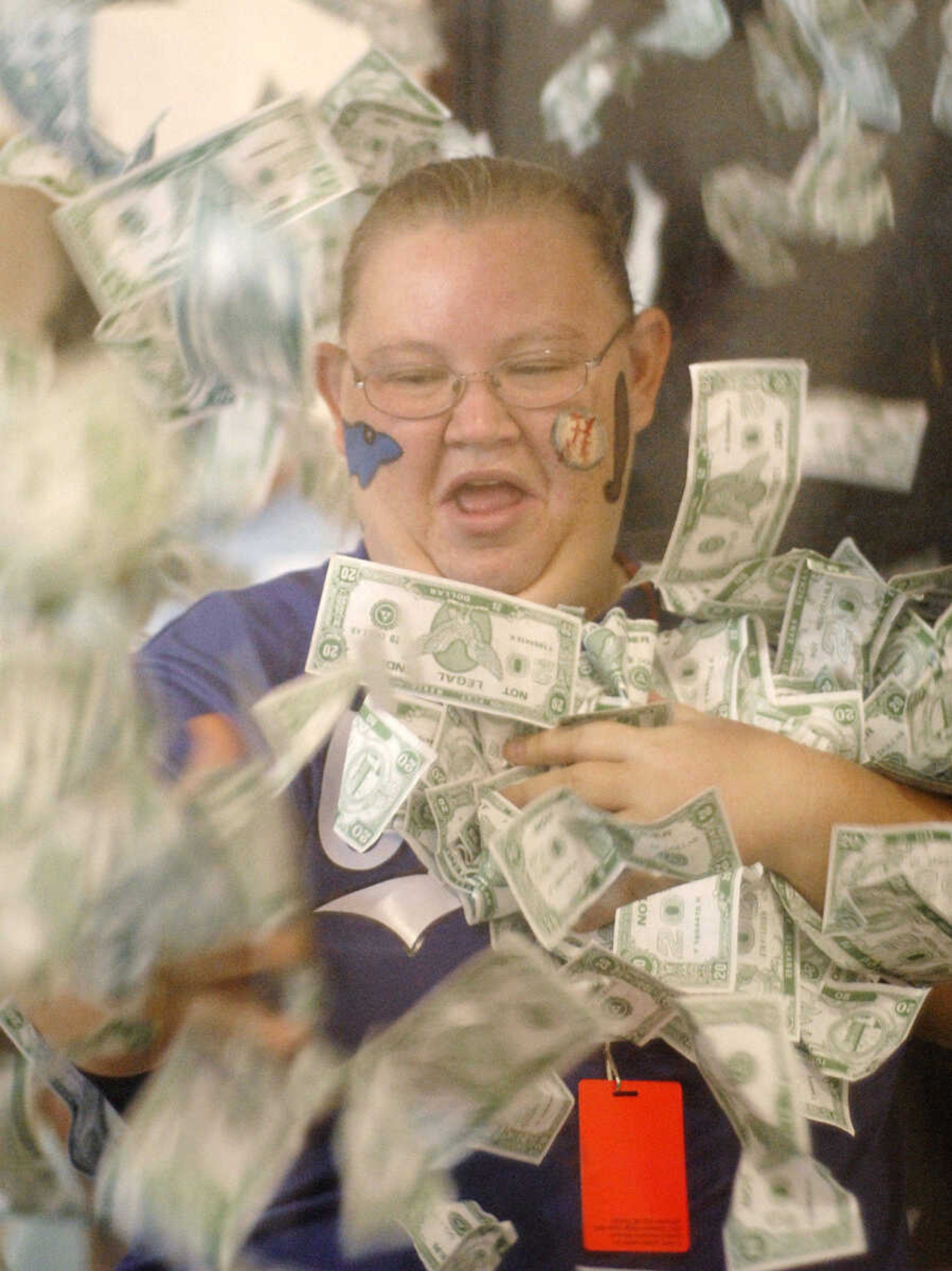 LAURA SIMON ~ lsimon@semissourian.com
Stephanie Littrell takes a turn in the money booth at Victory Village inside the the Osage Centre Saturday, August 13, 2011 in Cape Girardeau.