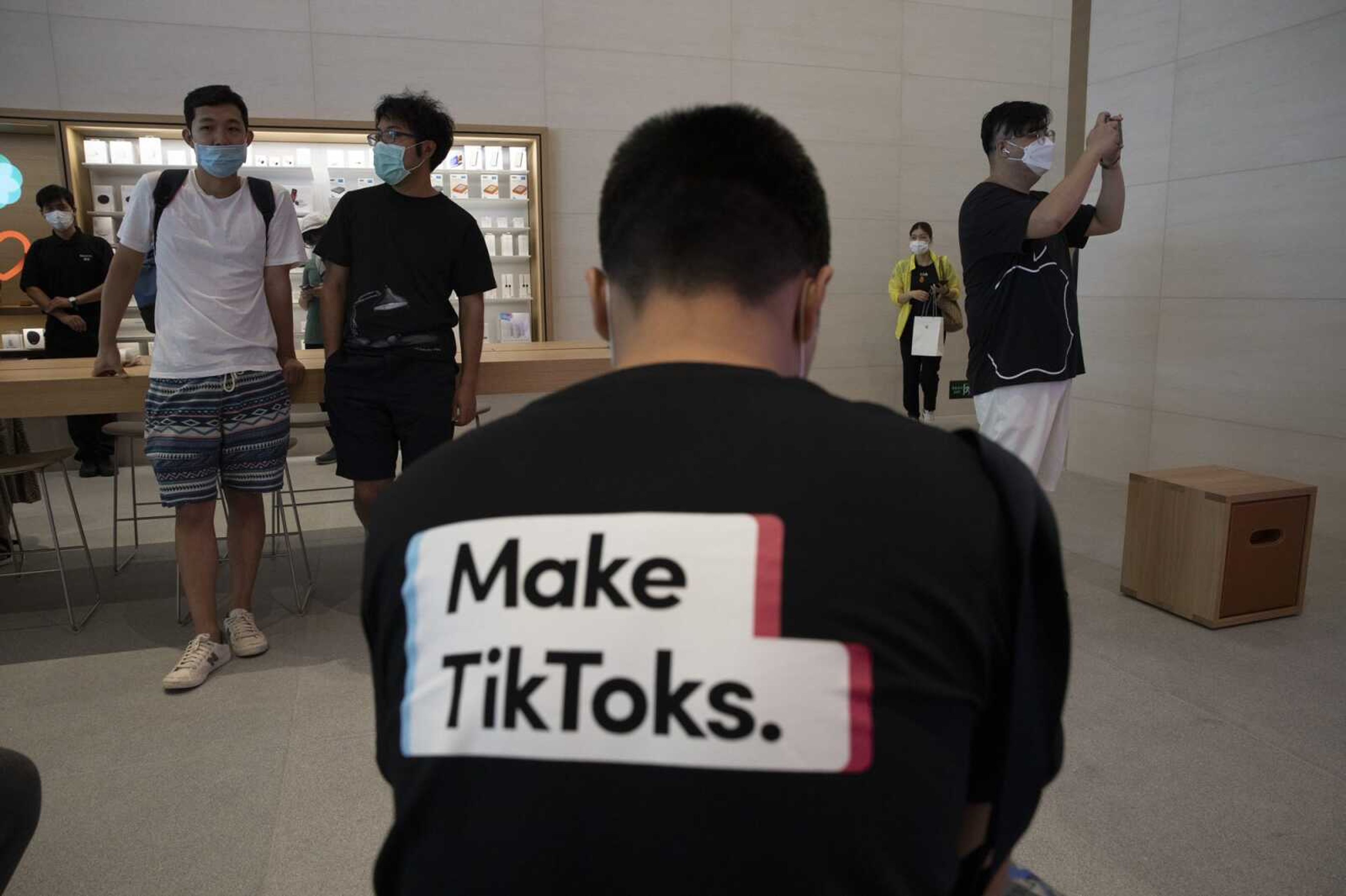 A man wearing a shirt promoting TikTok is seen at an Apple store July 17 in Beijing.