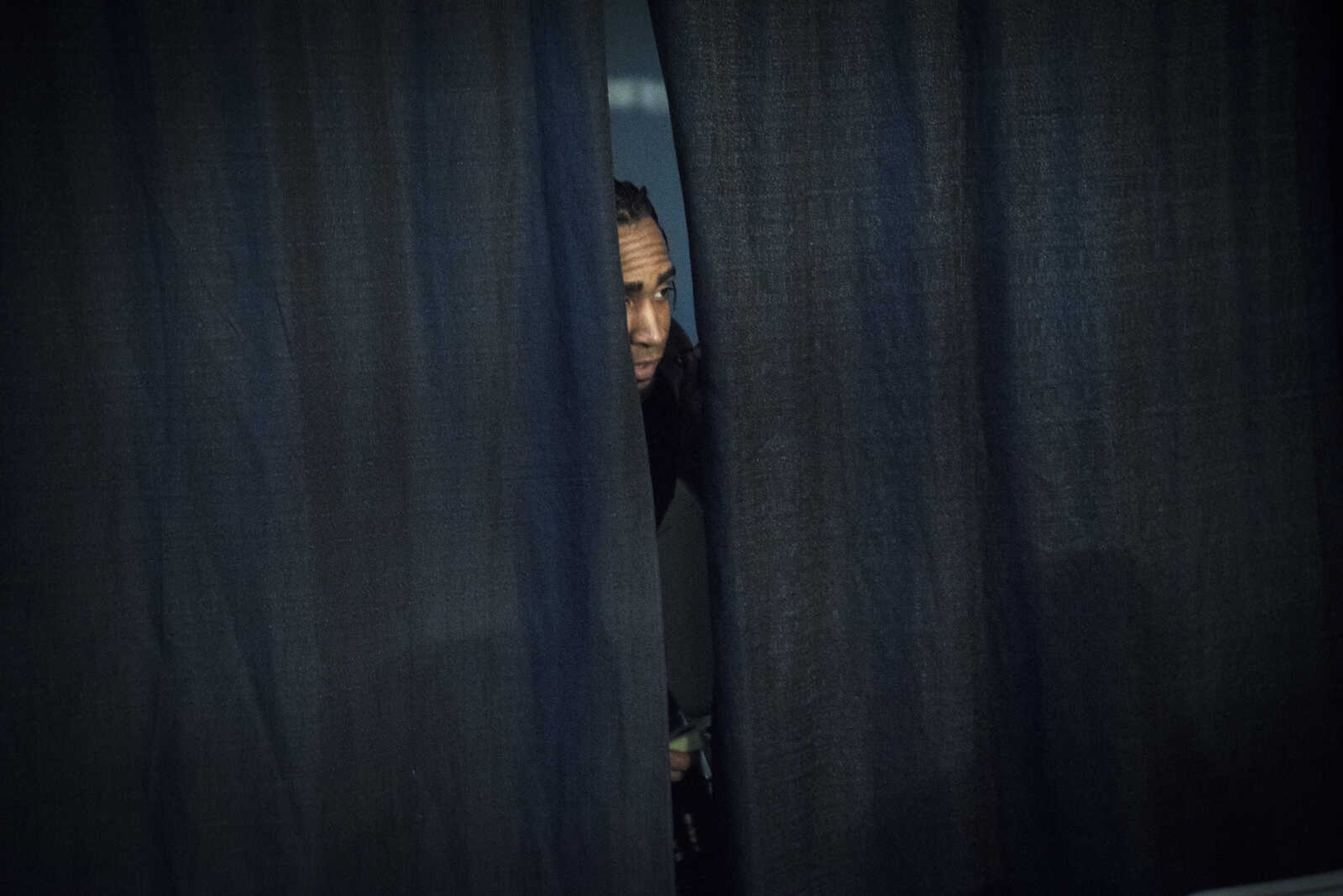 D'mone Solavino peaks behind the curtain before the Cape Championship Wrestling match Saturday, Jan. 28, 2017 at the Arena Building in Cape Girardeau.