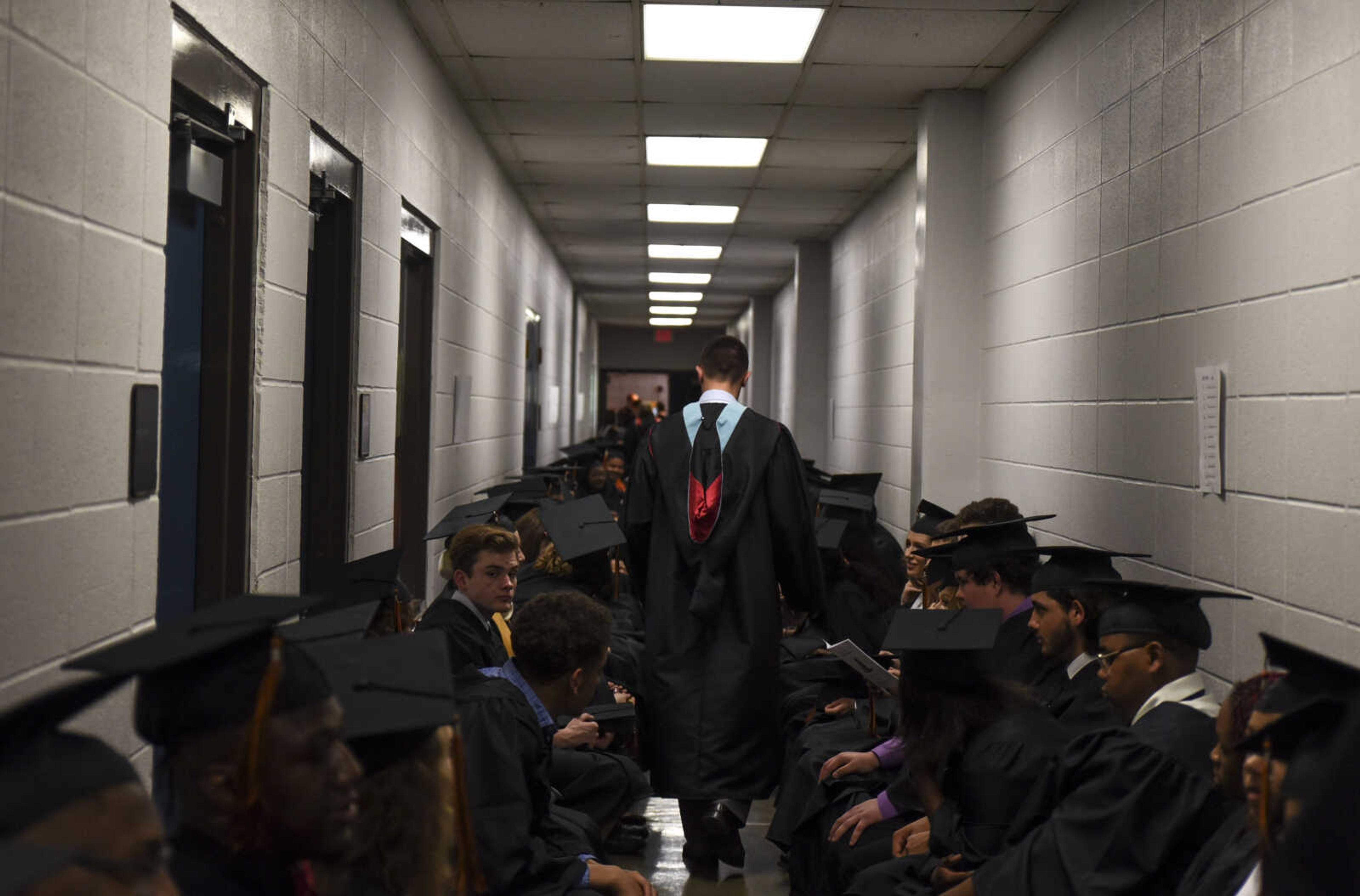 Graduates sit in the hallway before the start of the Cape Central High School Class of 2018 graduation Sunday, May 13, 2018 at the Show Me Center in Cape Girardeau.