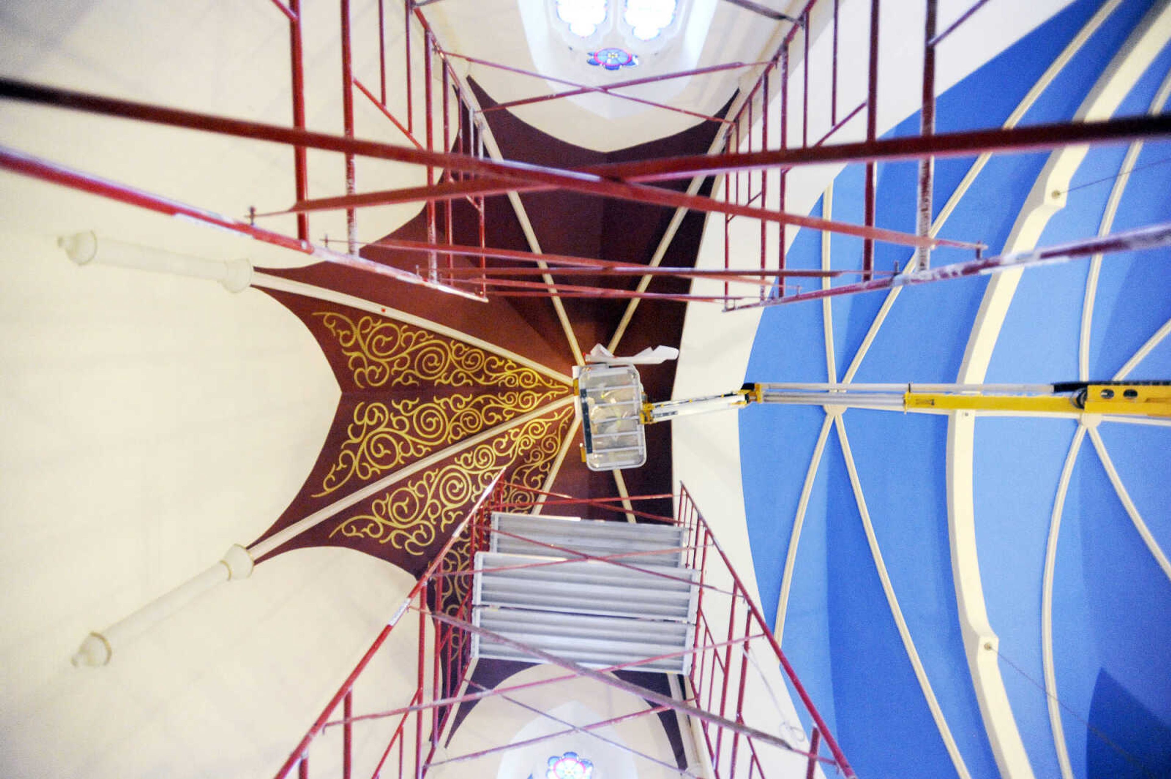 LAURA SIMON ~ lsimon@semissourian.com

Gary Westand Roy Diamond make their way to the ceiling above the altar area in a cherry picker to work on the stenciling at St. John's Catholic Church in Leopold, Missouri.