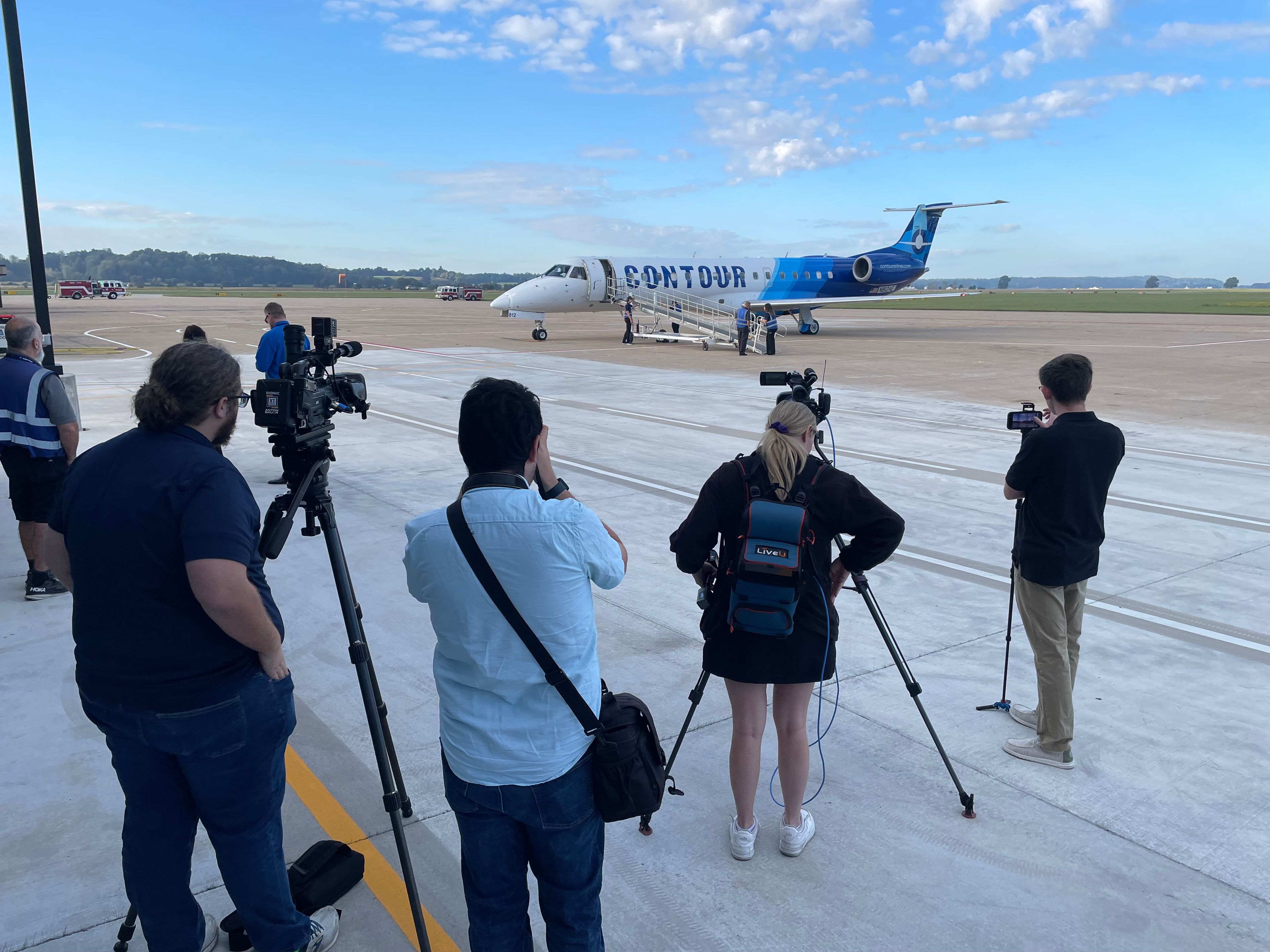 Media members watch as the first of the new flights to Chicago prepares to take-off.