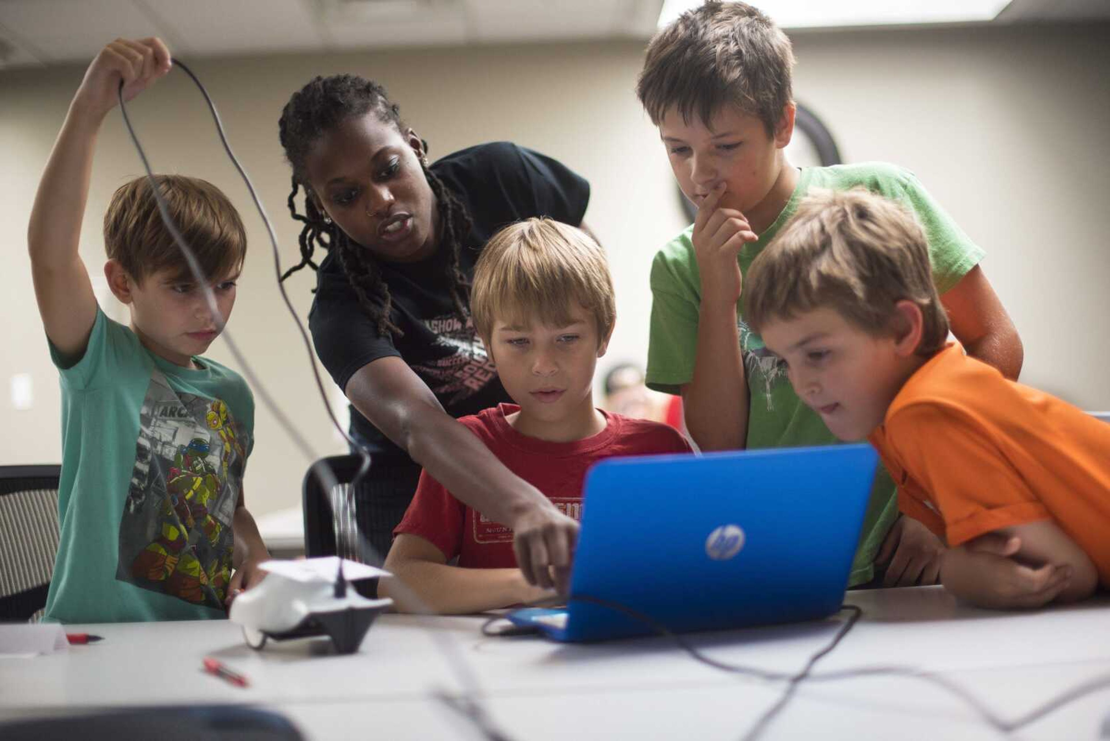 Fashion description:Instructor Andrea Cox helps out Stratton Williams, Nathan Harris, Grady Warren and Mason Hanners with their robot "The Finch" during the Code Camp: Coding with The Finch with the Marquette Technology Institute Monday, July 17, in Cape Girardeau.