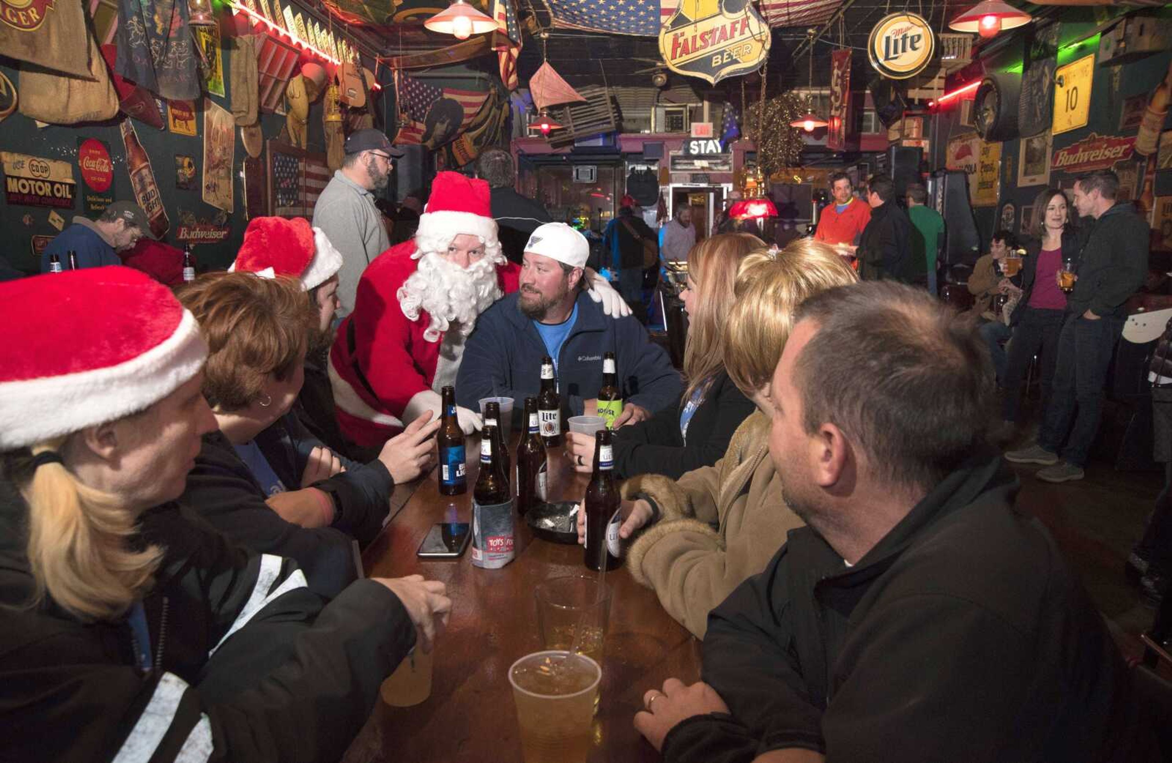 Andy Robert, dressed as Santa, places his arm around Rick Biri during the 2016 Happy Slapowitz Toy Bash at The Rude Dog Pub in Cape Girardeau. The event raises money and toys for children along with providing food and live music at each venue. This year's toy bash is tonight.