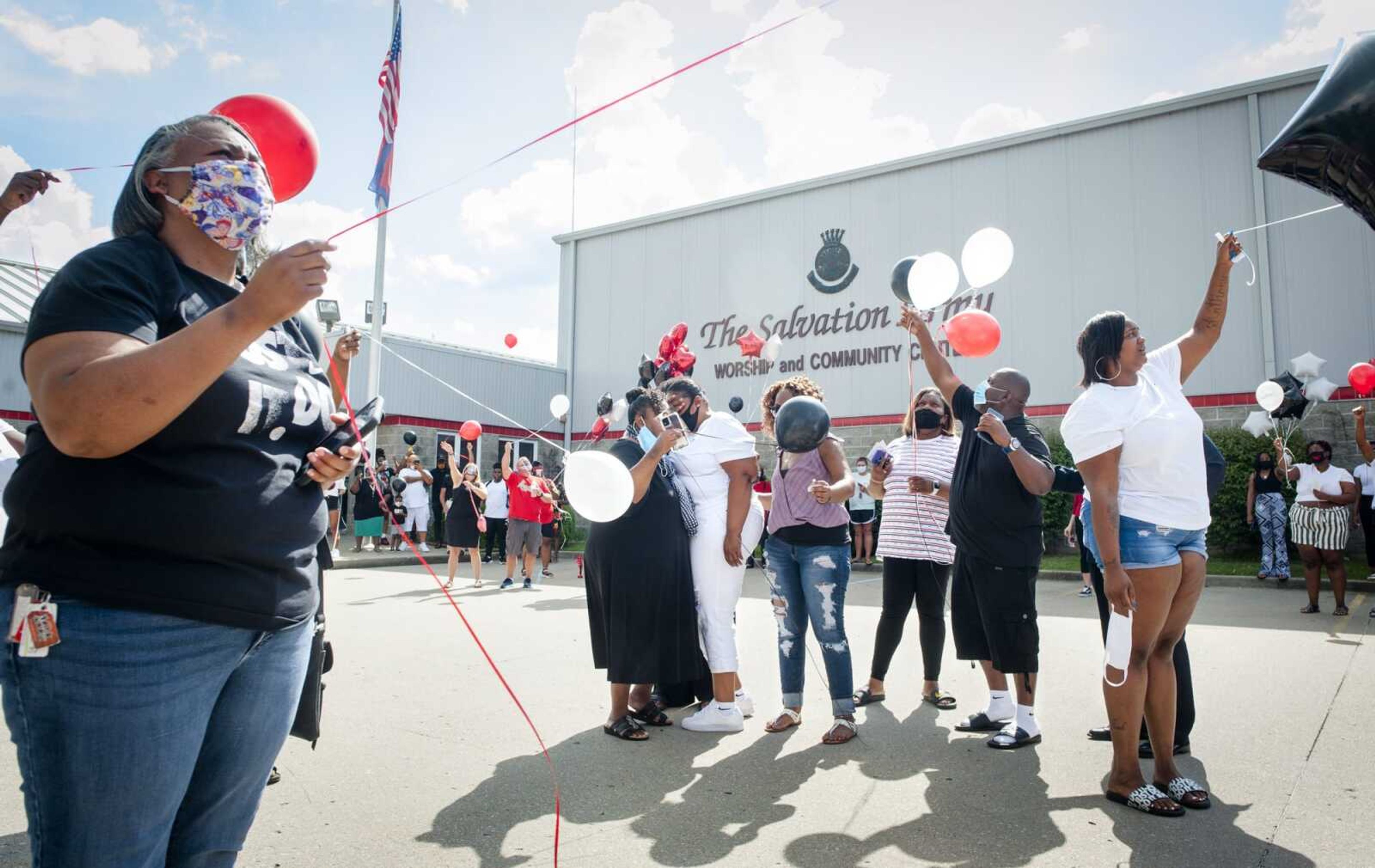 Anthony Miller's family stands in the center of the Salvation Army parking lot with hundreds of mourners to release balloons in memory of Anthony Miller after a candlelight service Saturday in Cape Girardeau.