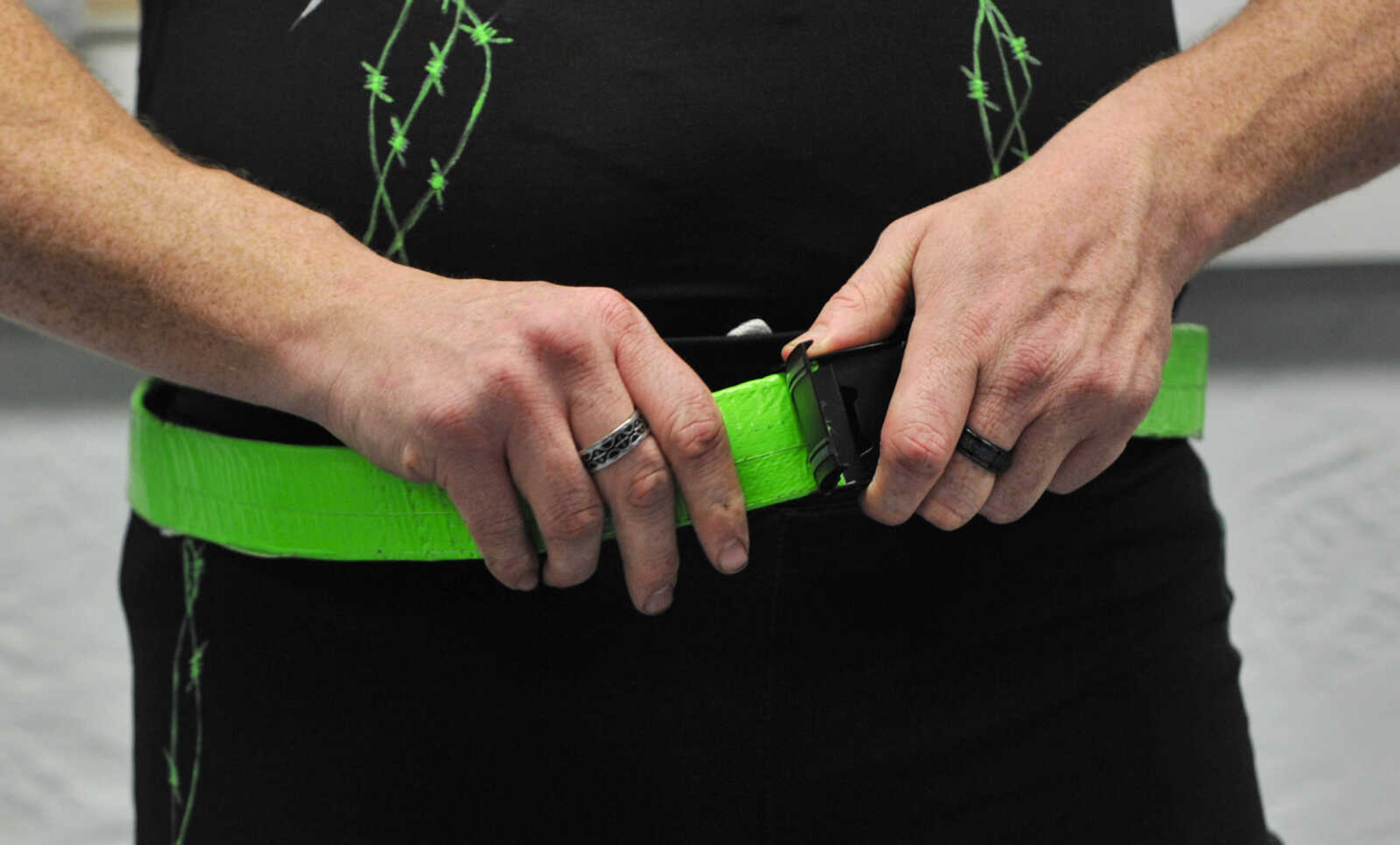 CCW wrestler Brandon "Barbwire" Anderson fastens his belts before a One Night Riot event Saturday, Feb. 24, 2018, at the Arena Building in Cape Girardeau.