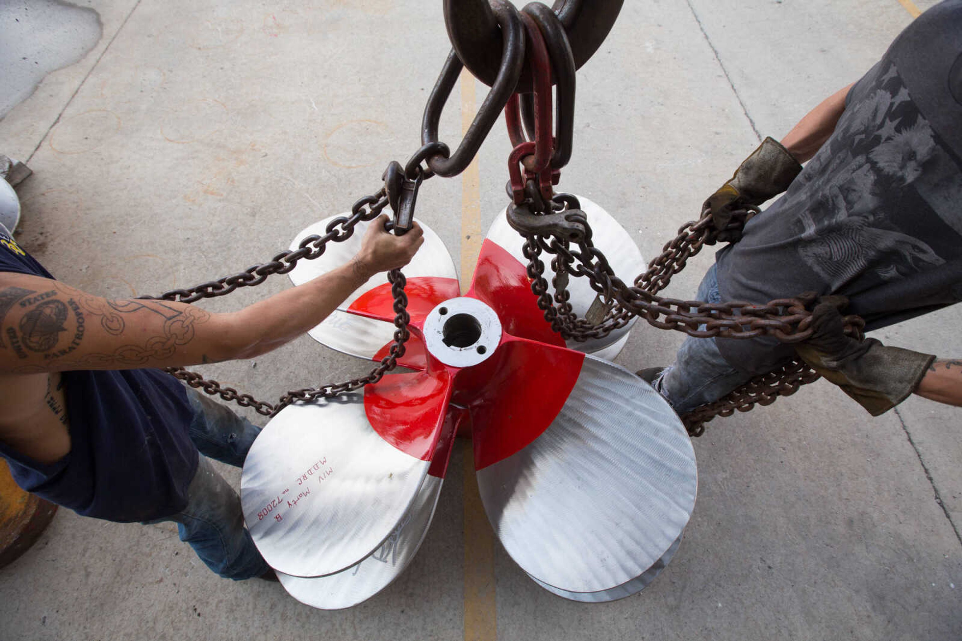 GLENN LANDBERG ~ glandberg@semissourian.com

Cousins, Keegan and Kyler Hale hook up chains to a propeller being moved outside the repair shop at Missouri Dry Dock and Repair Co. in Cape Girardeau Wednesday, July 28, 2016.