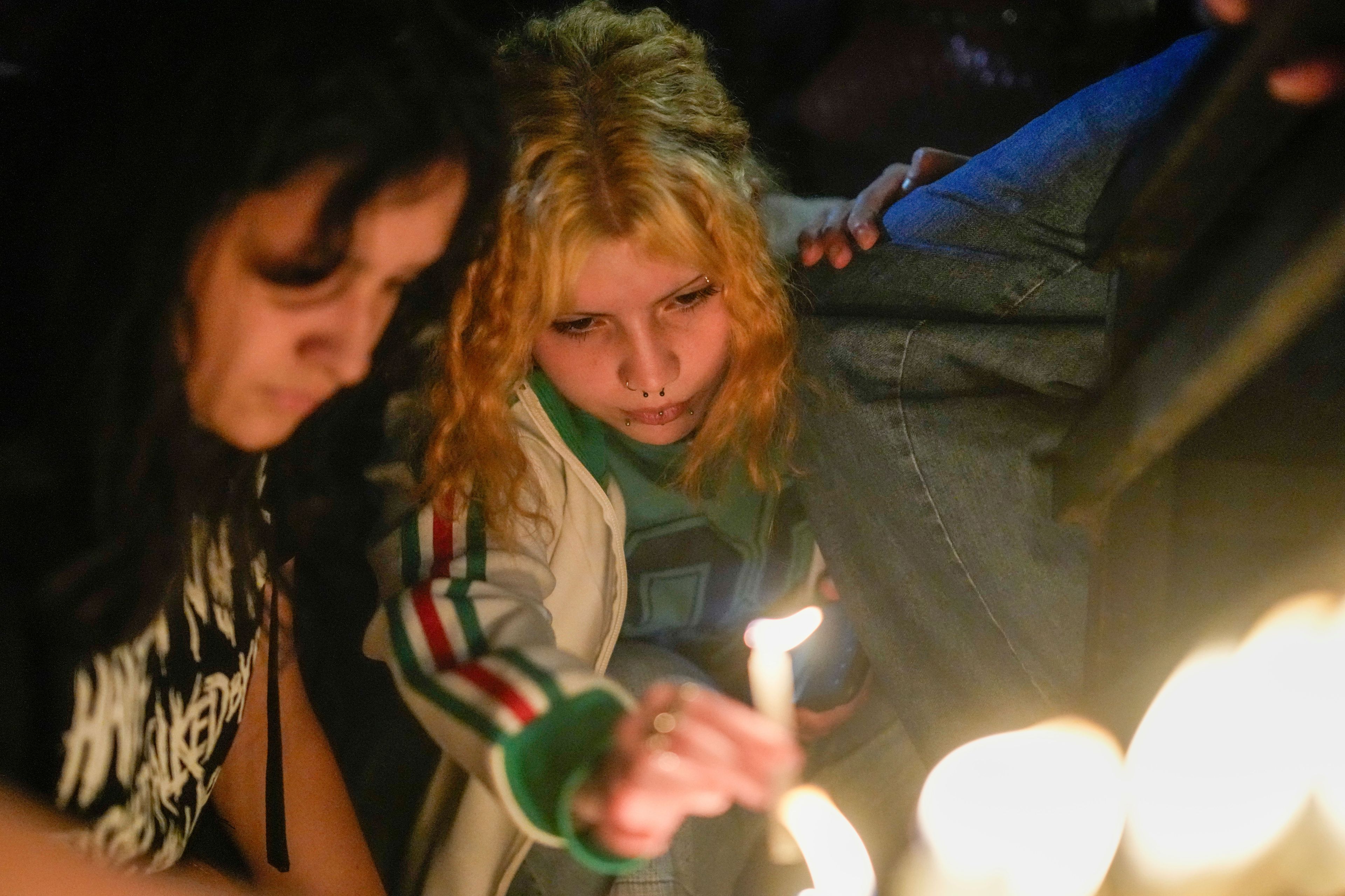 Fans light candles outside the hotel where former One Direction singer Liam Payne was found dead after he fell from a balcony in Buenos Aires, Argentina, Oct. 16, 2024. (AP Photo/Natacha Pisarenko)