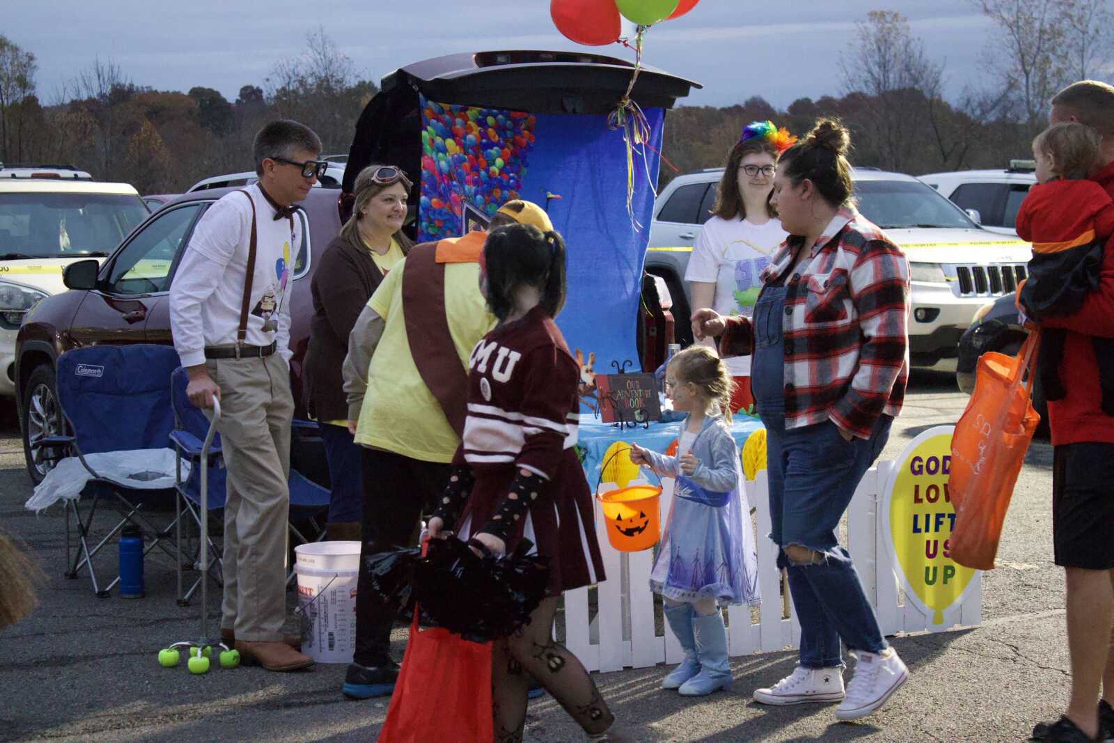 Bill, Carisa, Cody and Morgan Sullinger hand out 
candy from their trunk on Monday, Oct. 31 at Lynwood Baptist Church's 'Trunk or Treat' event. The family dressed as characters from 
the movie 'Up!' (Photo by Jeffery Long)