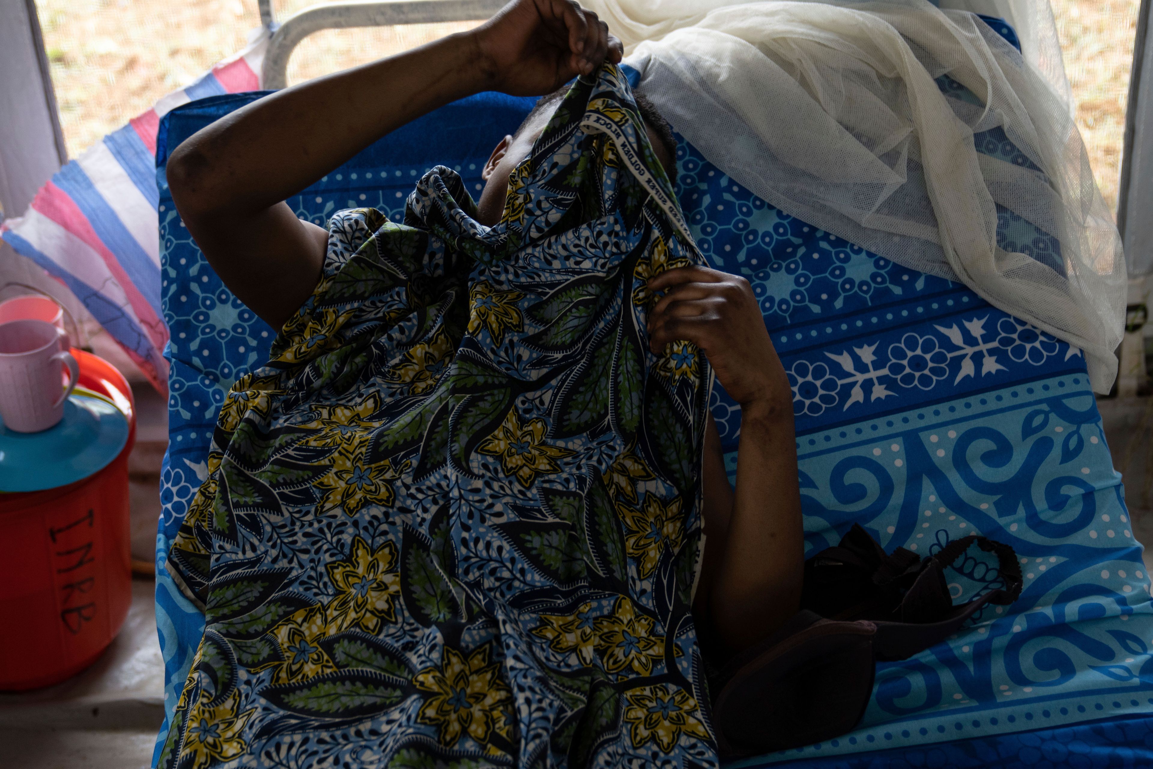 A sex worker with mpox lies in a hospital in Kamituga, in eastern Congo's South Kivu province, which is the epicenter of the world's latest outbreak of the disease, on Sept. 4, 2024. (AP Photo/Moses Sawasawa)