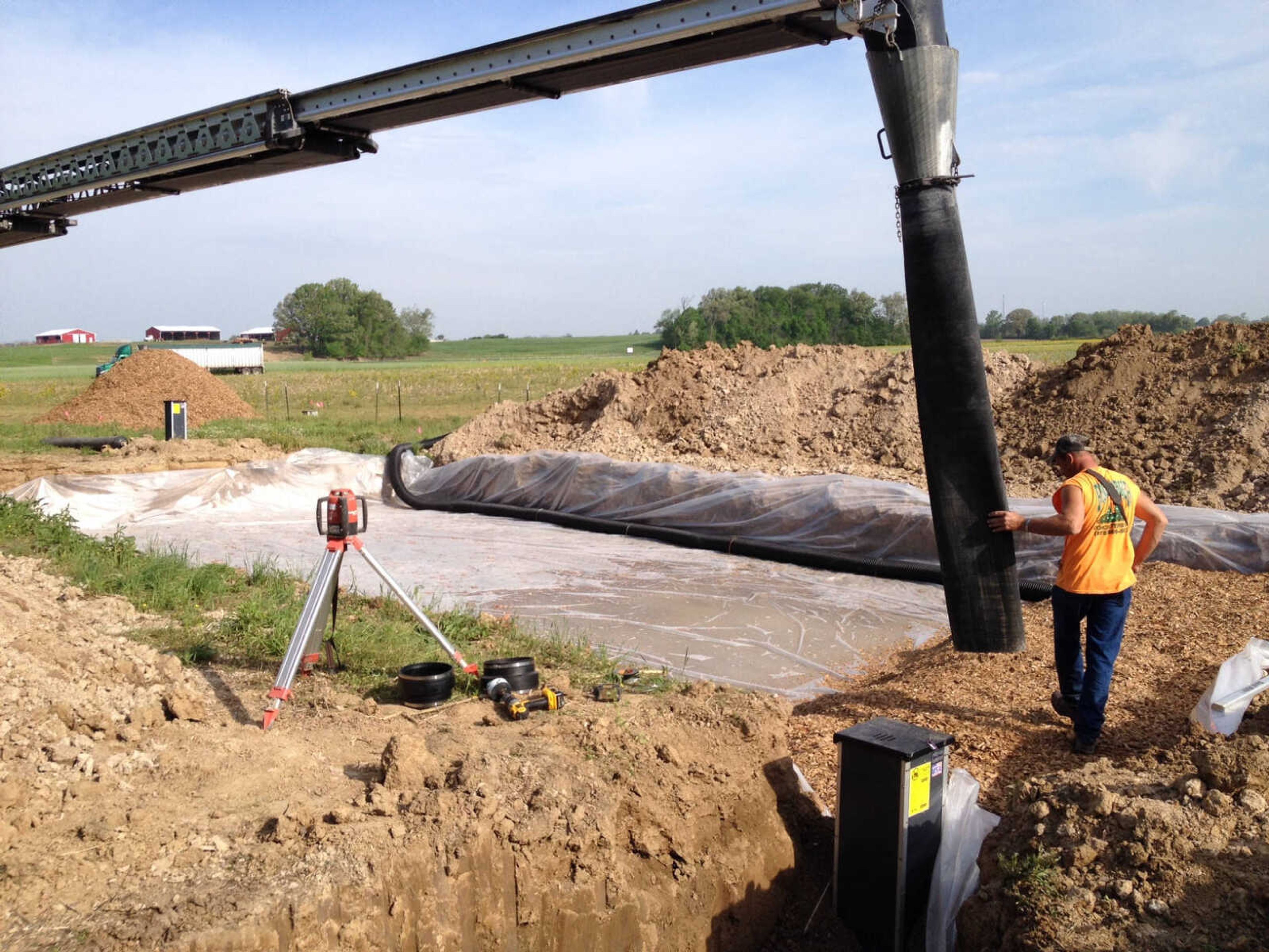 Kiefner Brothers of Cape Girardeau install the bioreactor last week at Southeast Missouri State University's David M. Barton Agriculture Research Center in Gordonville. (Courtesy Michael Aide)