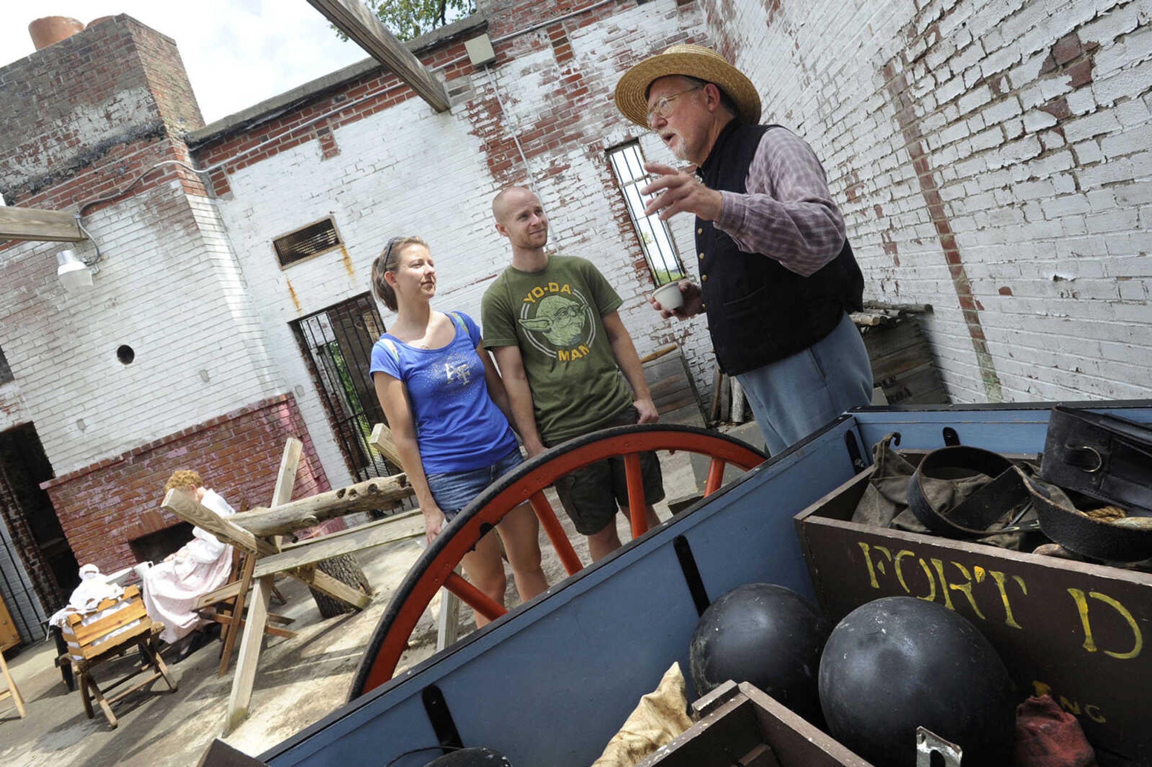 FRED LYNCH ~ flynch@semissourian.com
Turner Brigade member Scott House discusses Civil War history Monday, Sept. 2, 2013 with Marcie Mueth of Columbia, Mo. and Tim Forck of Ashland, Mo. inside the replica powder house at the Fort D Historic Site in Cape Girardeau.