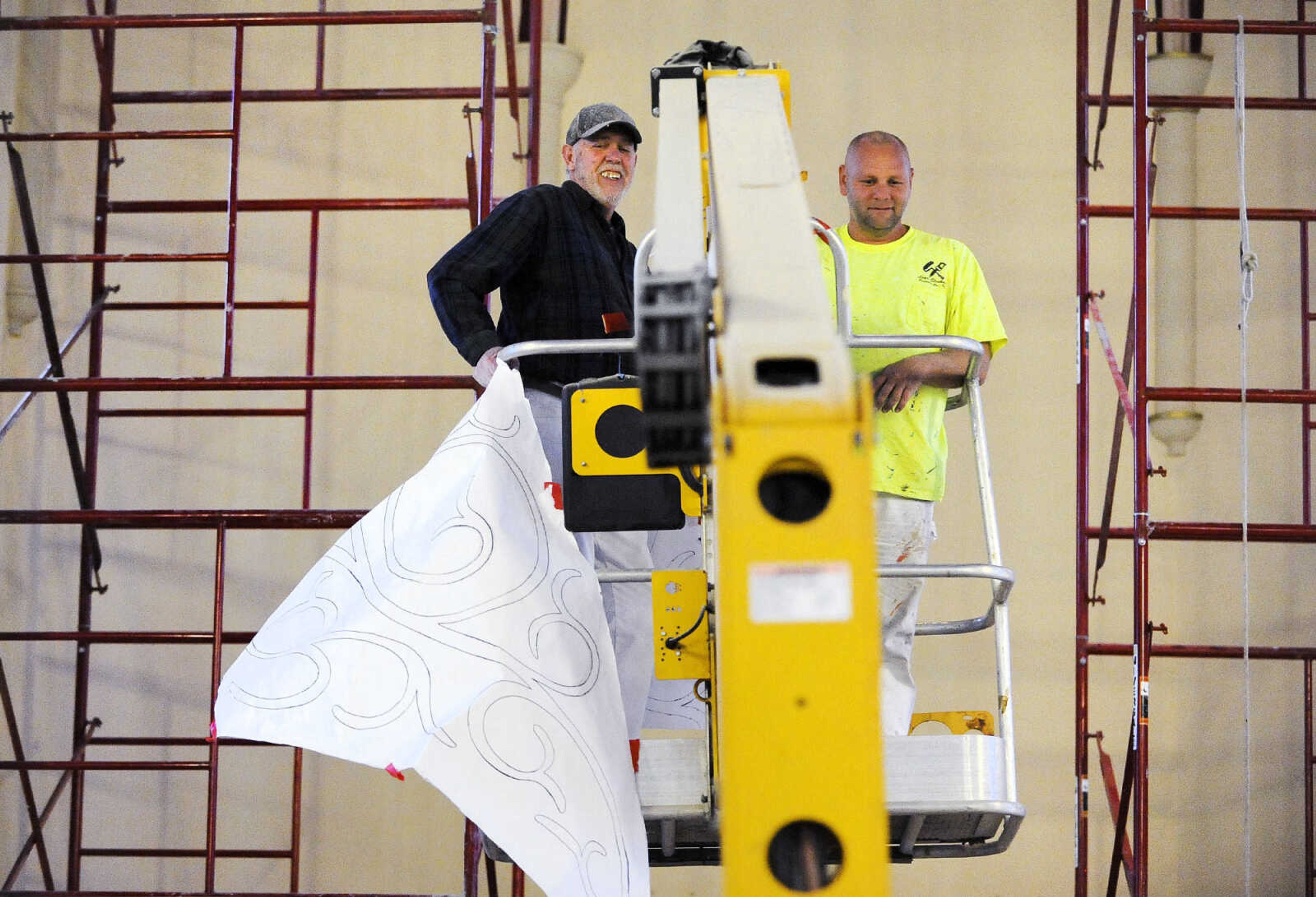 LAURA SIMON ~ lsimon@semissourian.com

Gary West, left, and Roy Diamond make their way to the ceiling above the altar in a cherry picker to work on the stenciling at St. John's Catholic Church in Leopold, Missouri.