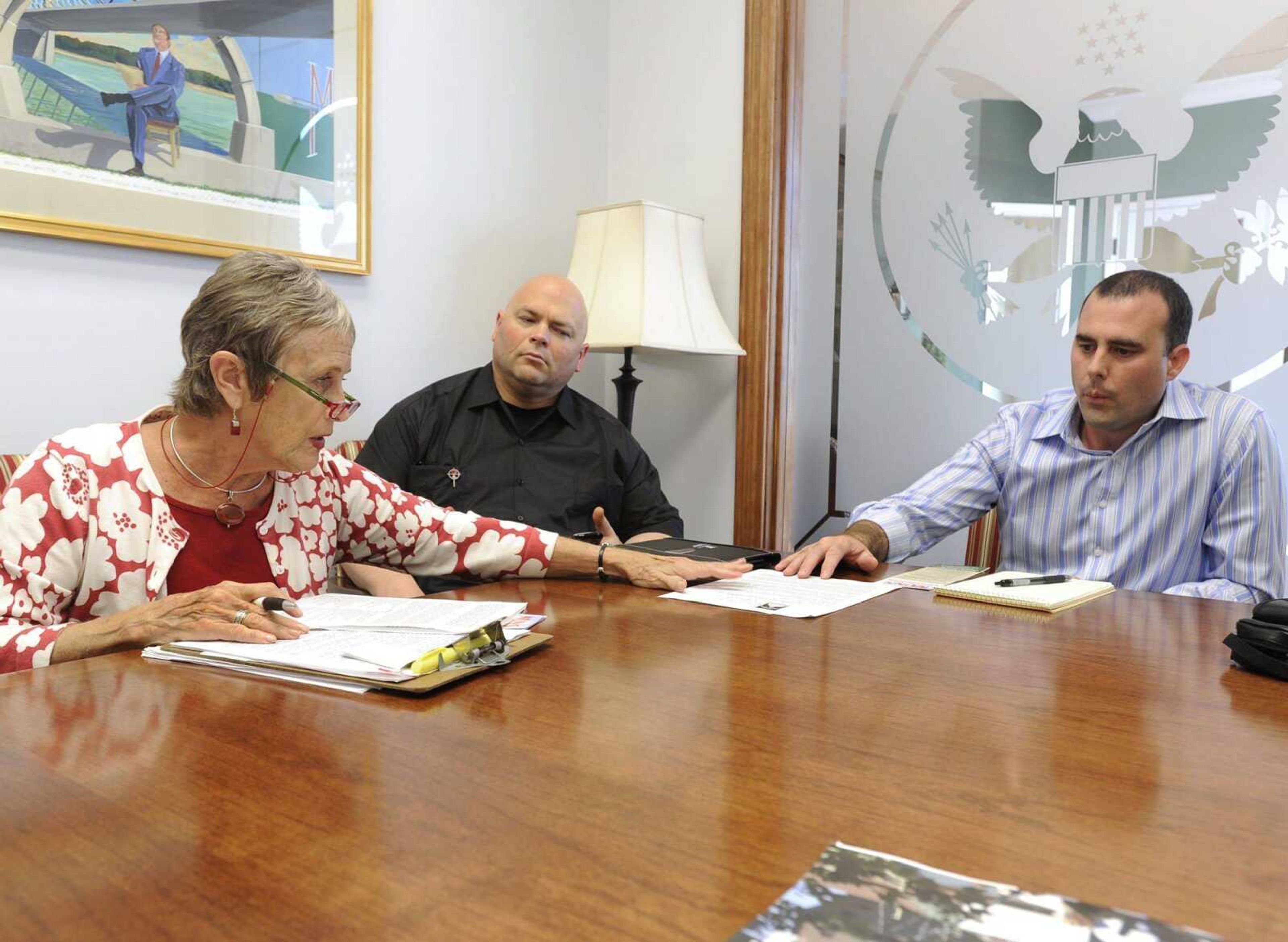 Alice Kitchen, left, of Kansas City, retired social worker and member of the Loretto Catholic order community, speaks Thursday, Sept. 6, 2012 to Josh Haynes, chief of staff for U.S. Rep. Jo Ann Emerson, as Brother Darryl Charron, center, of Liberty, Mo., member of the Missionaries of the Precious Blood, listens during a stop in Cape Girardeau of the Nuns on the Bus tour. (Fred Lynch)