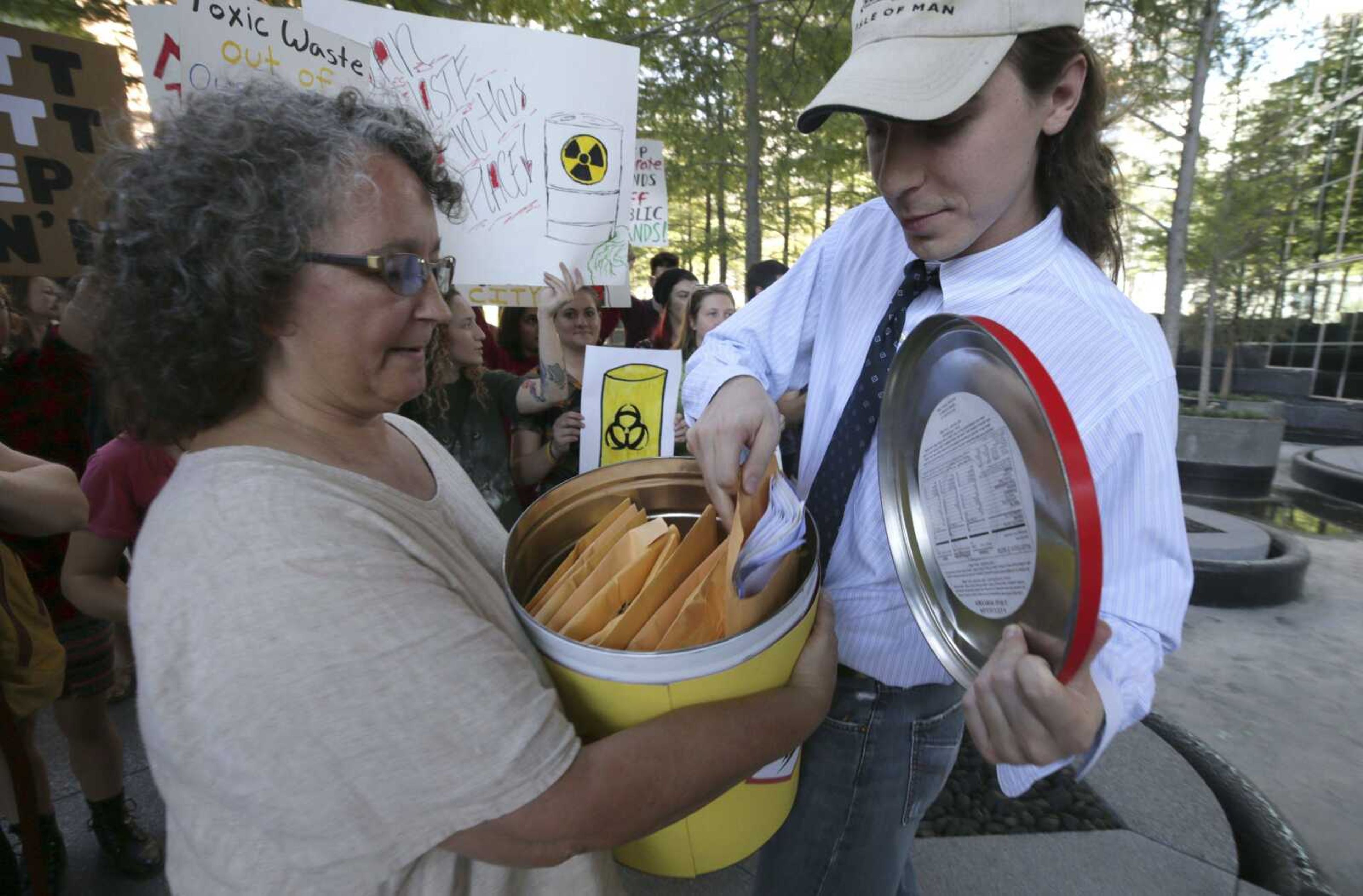 Robin Schneider, executive director for Texas Campaign for the Environment, left, and Corey Troiani prepare a barrel of over 2,300 letters from Texas families for delivery Thursday to the region VI office of the Environmental Protection Agency in Dallas. The letters to the EPA are calling for saving federal cleanup programs under the Trump administration.