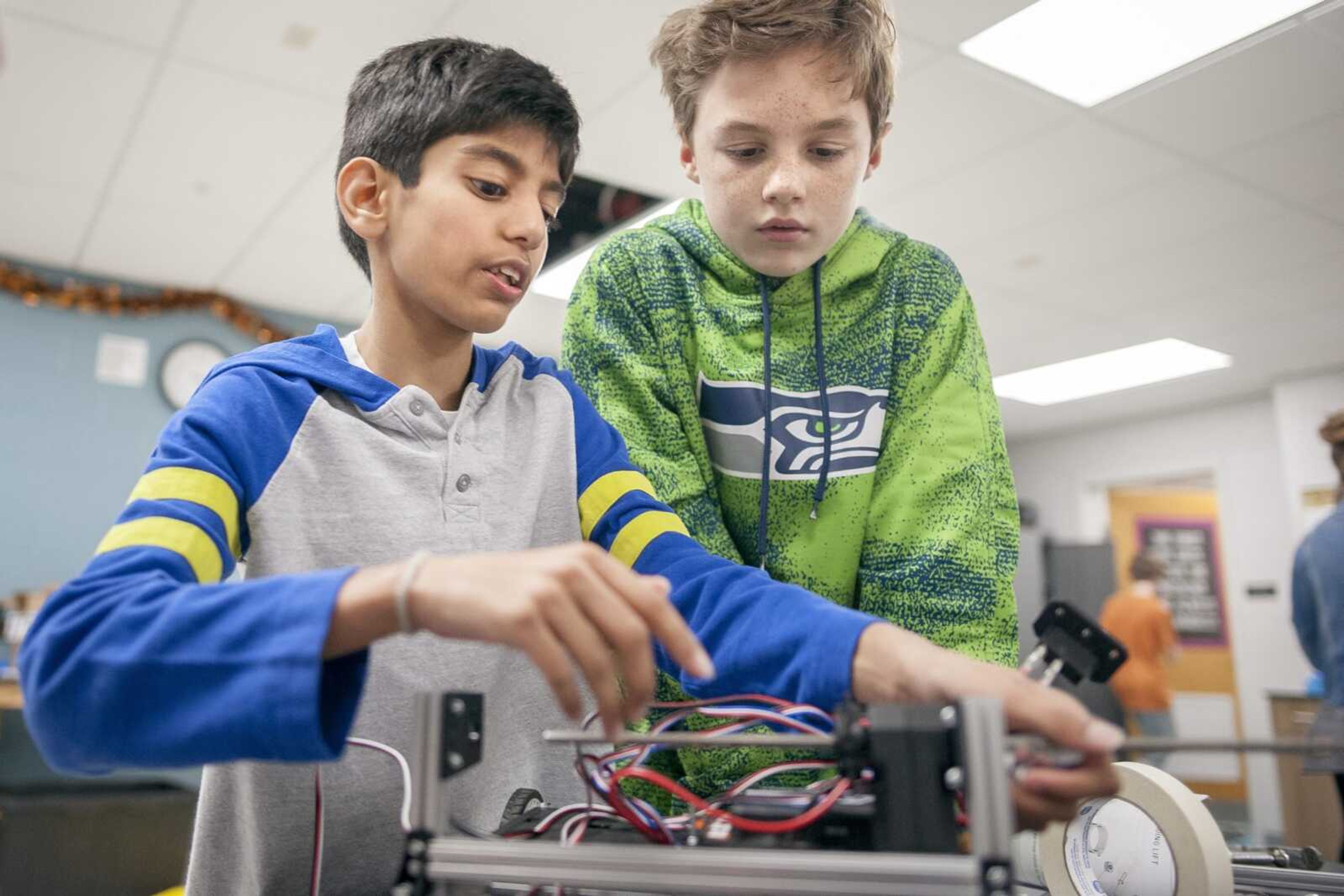 Robotics club member Dulina Dias, 12, left, works on a robot  with Drew Ferguson, right, during a robotics club meeting Jan. 16 at Terry W. Kitchen Central Junior High School in Cape Girardeau.