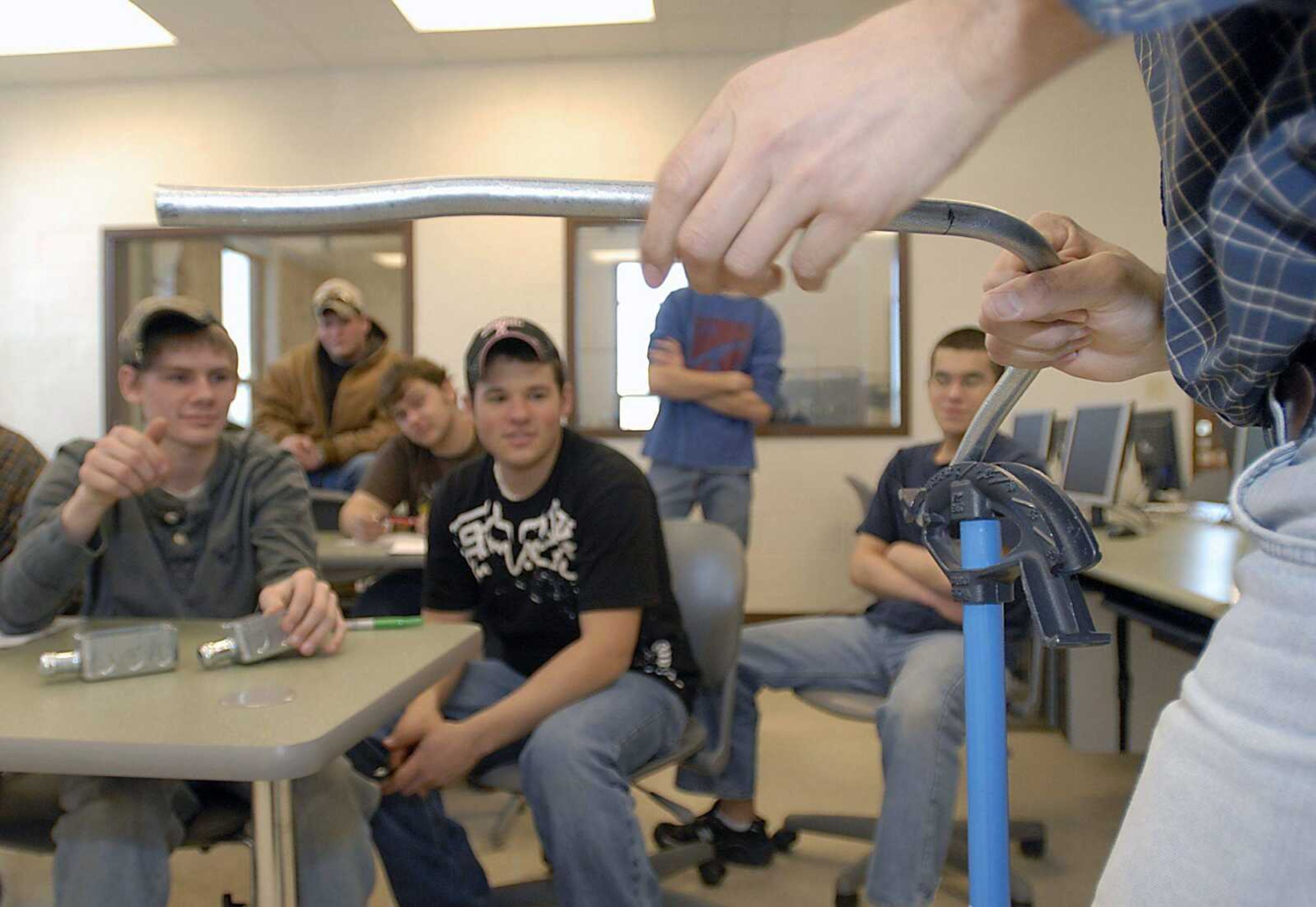 Instructor Tim Mayfield, right, taught his electrical trades class some tricks to bending conduit Friday at the Cape Girardeau Career and Technology Center. Electrical trades and woodworking/cabinet-making, classes are held in a newly completed annex at the CTC. (Kit Doyle)