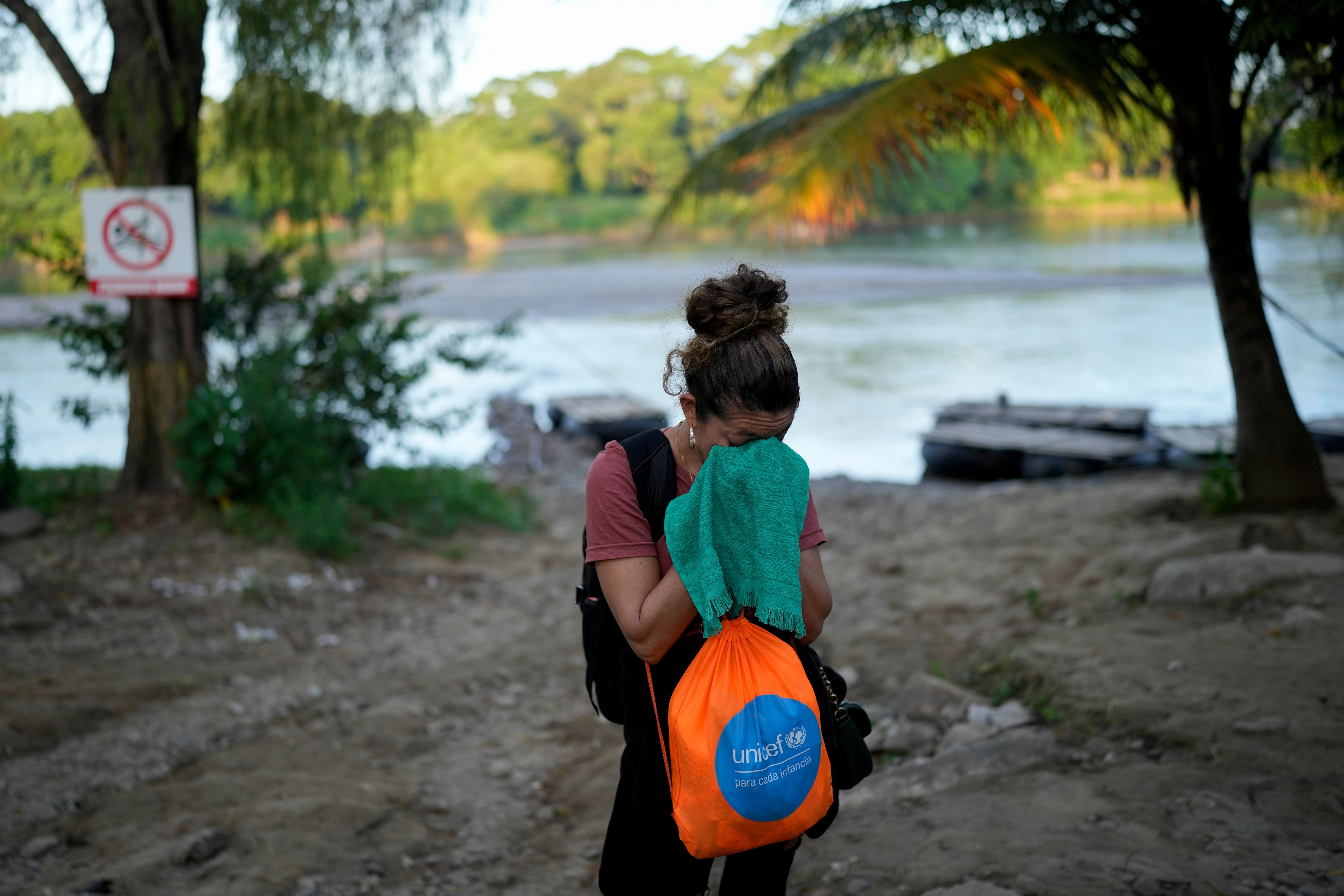 A migrant from Honduras waits to cross the Suchigate River from Tecum Uman, Guatemala, to Mexico, Tuesday, Oct. 29, 2024. (AP Photo/Matias Delacroix)