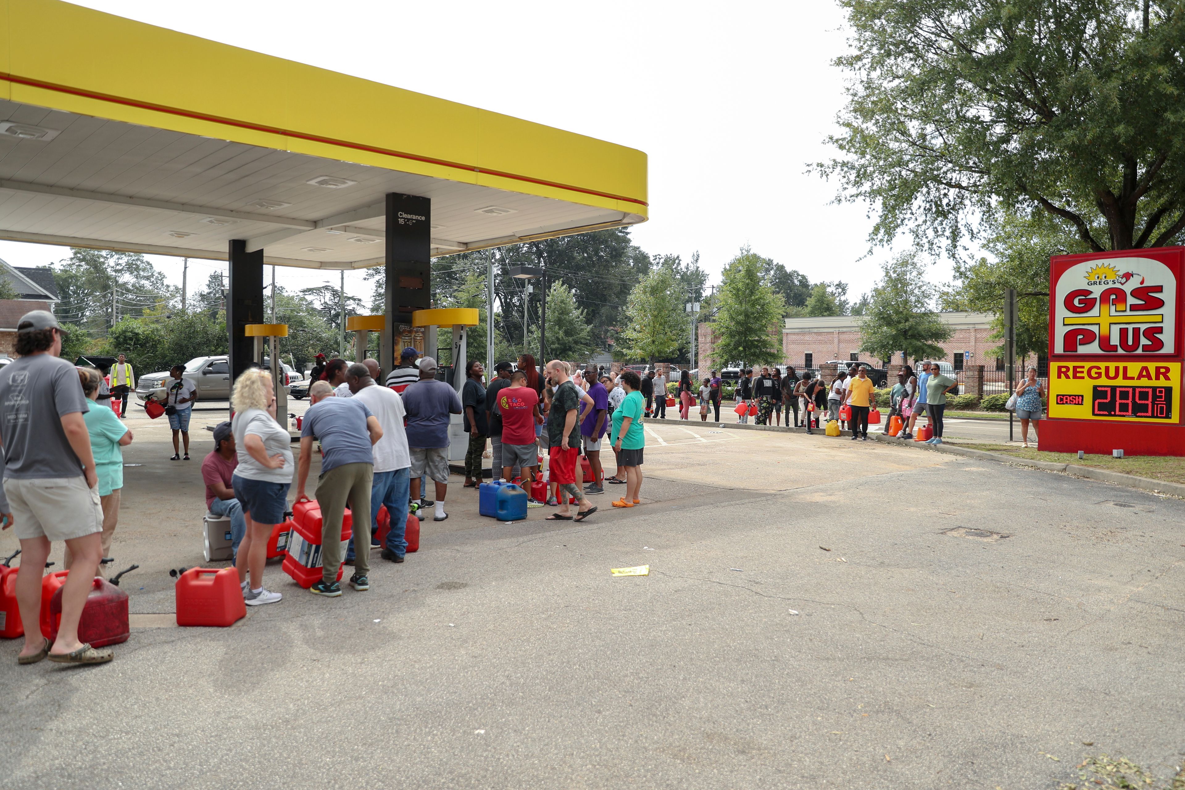 Residents wait in line with gas cans at a Gas Plus gas station in the aftermath of Hurricane Helene Sunday, Sept. 29, 2024, in North Augusta, S.C. (AP Photo/Artie Walker Jr.)