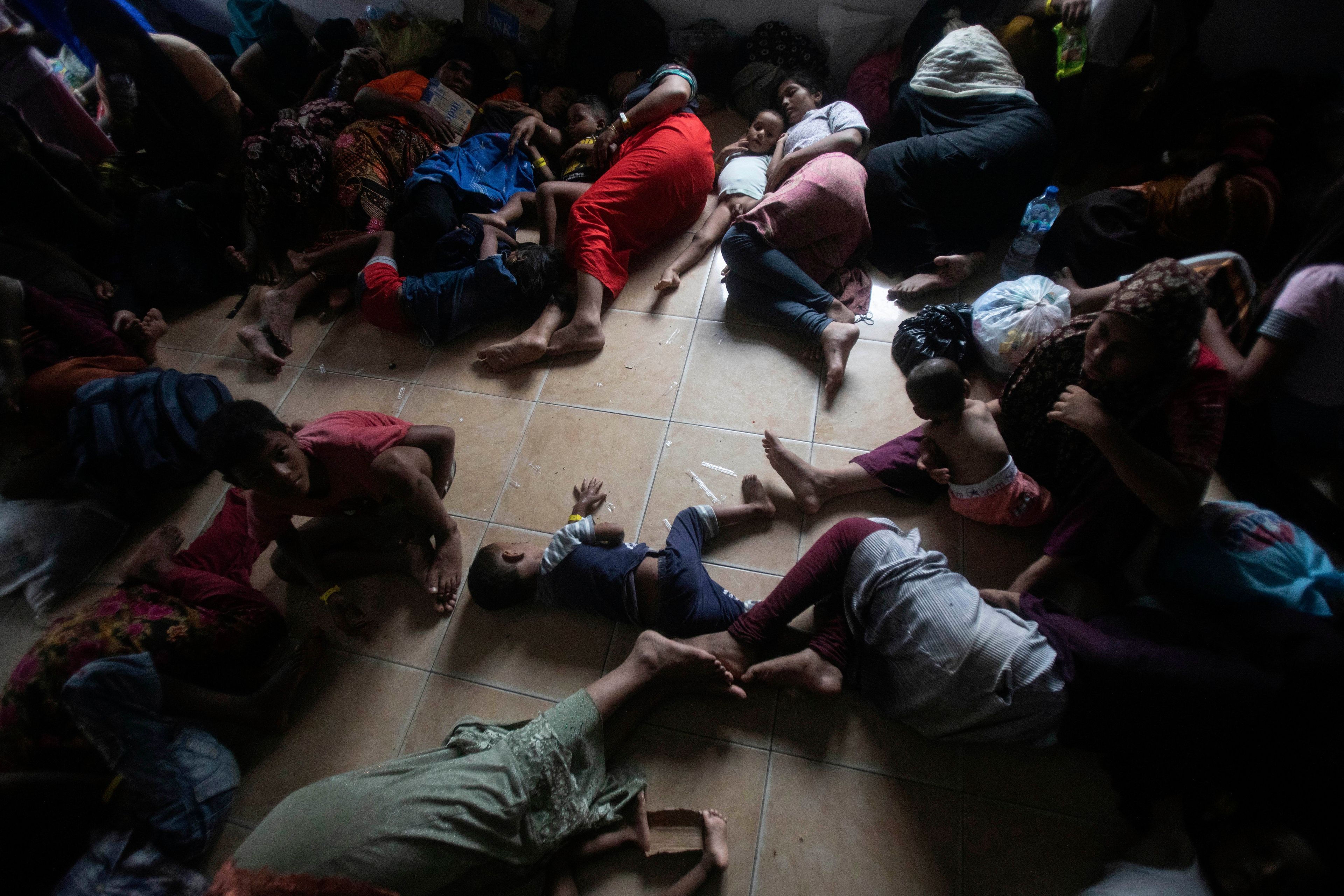 Newly arrived Rohingya Muslims rest on the floor at a temporary shelter in Pantai Labu, North Sumatra, Indonesia, Friday, Oct. 25, 2024. (AP Photo/Binsar Bakkara)