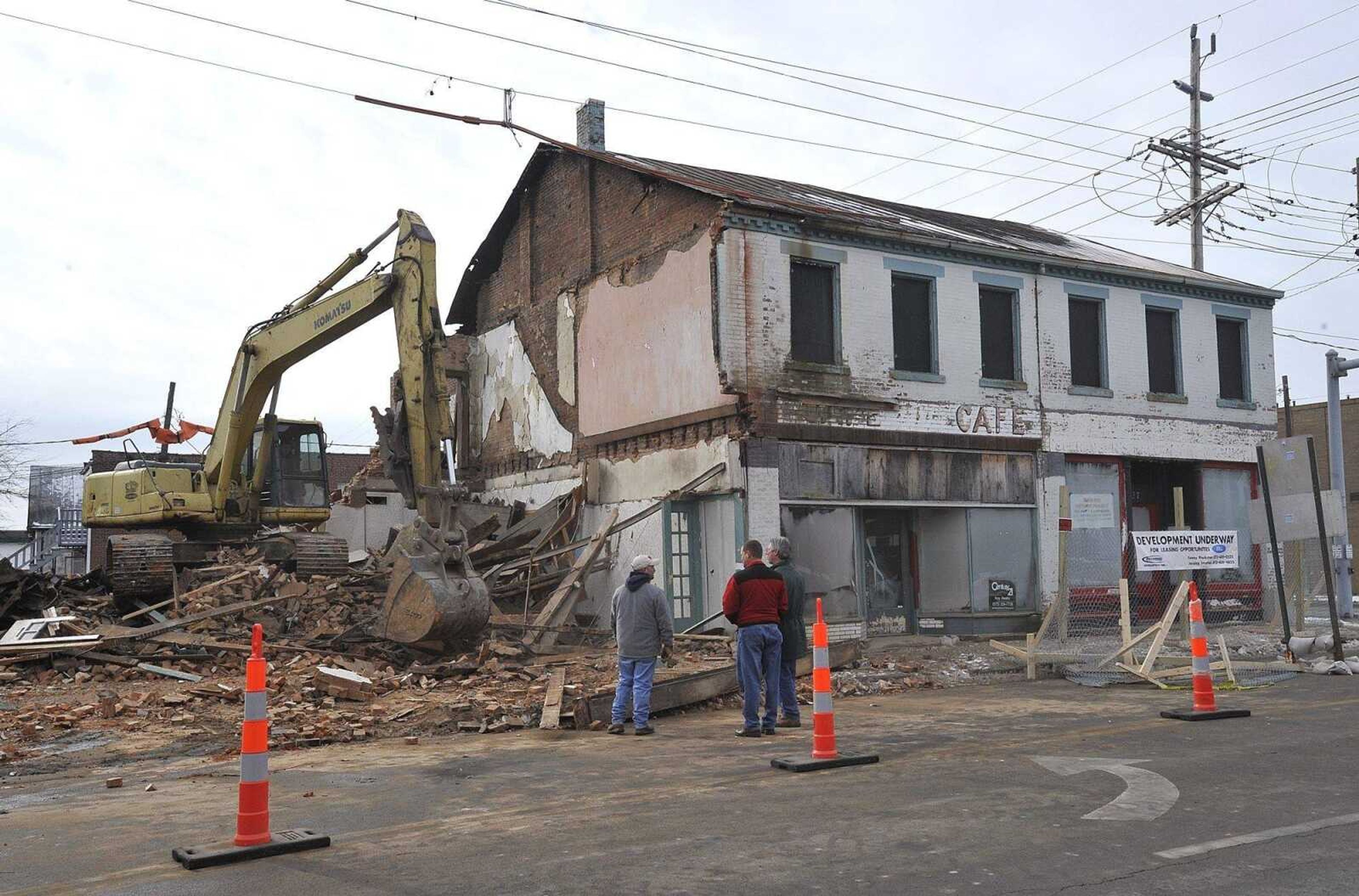 The building at 633 Broadway was razed next to buildings at 635 and 637 Broadway Monday morning at the corner of Sprigg Street in Cape Girardeau. The developer hopes the remaining buildings can be refurbished. (Fred Lynch)