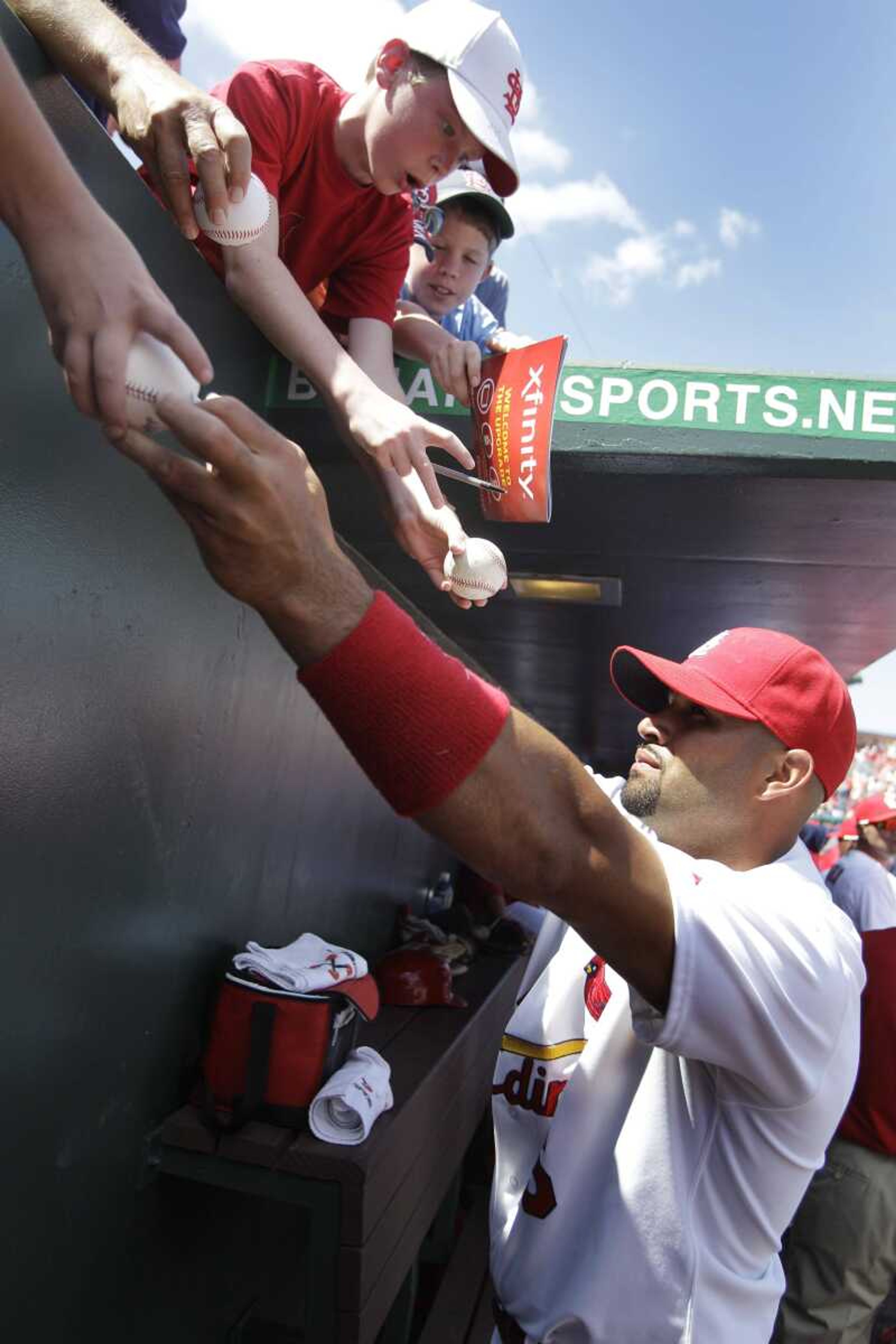 Cardinals first baseman Albert Pujols signs autographs before a spring training game last week in Jupiter, Fla. (Carlos Osorio ~ Associated Press)