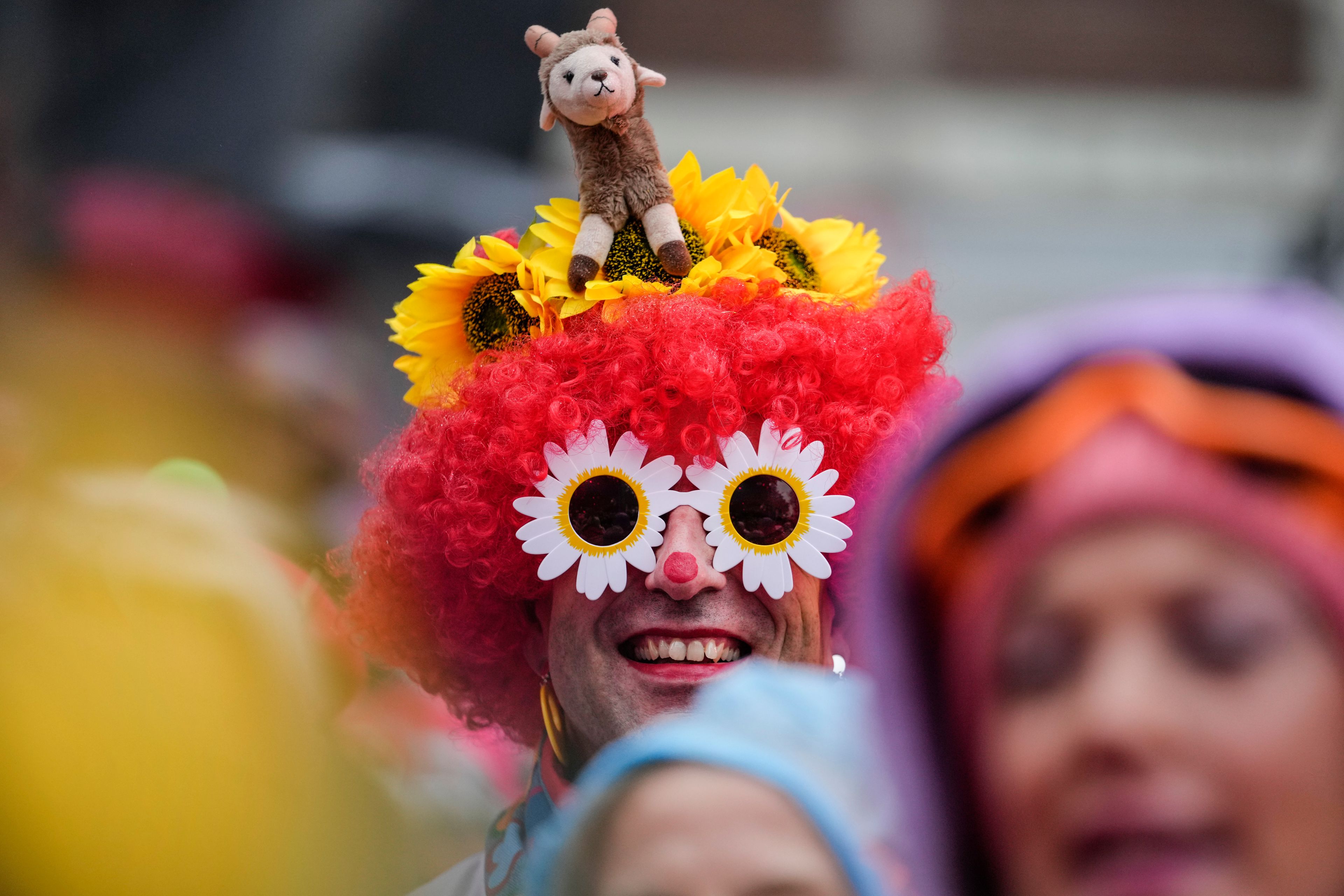 Costumed revelers celebrate at the central Heumarkt while tens of thousands of carnival fools take to the streets of Cologne, Germany, on Monday, November 11, 2024, heralding the official start of the carnival season. (AP Photo/Martin Meissner)