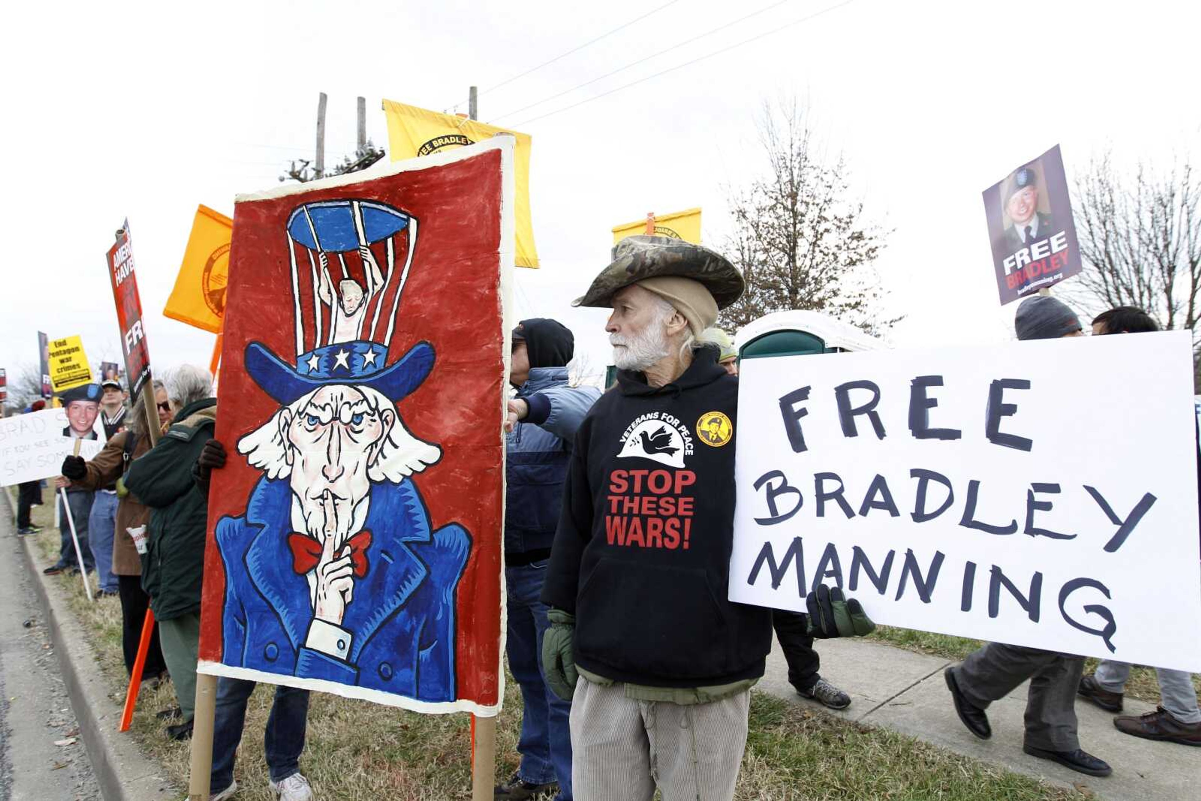 Hundreds of demonstrators march Saturday in support of Army Pfc. Bradley Manning, present on base at a military court hearing, outside Ft. Meade, Md. Prosecutors began presenting their case that Manning was the source of the WikiLeaks website&#8217;s collection of U.S. military and diplomatic secrets. (Jose Luis Magana ~ Associated Press)