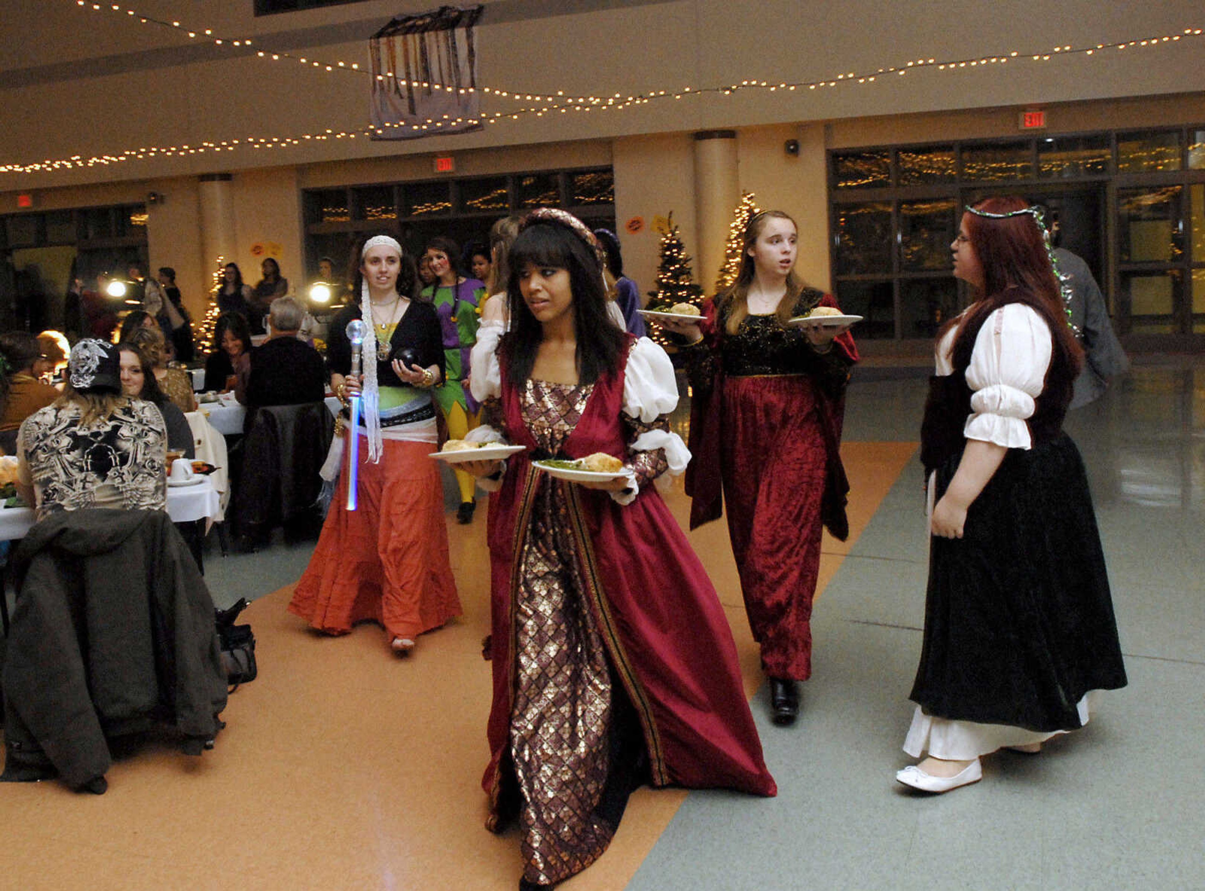 KRISTIN EBERTS ~ keberts@semissourian.com

Students serve dinner during the Central High School Choral Department's "Ye Olde Yuletide Madrigal Feaste," on Friday, Dec. 10, 2010, in Cape Girardeau. Students provided singing, food and entertainment as they transported guests back to Christmas in Renaissance England.