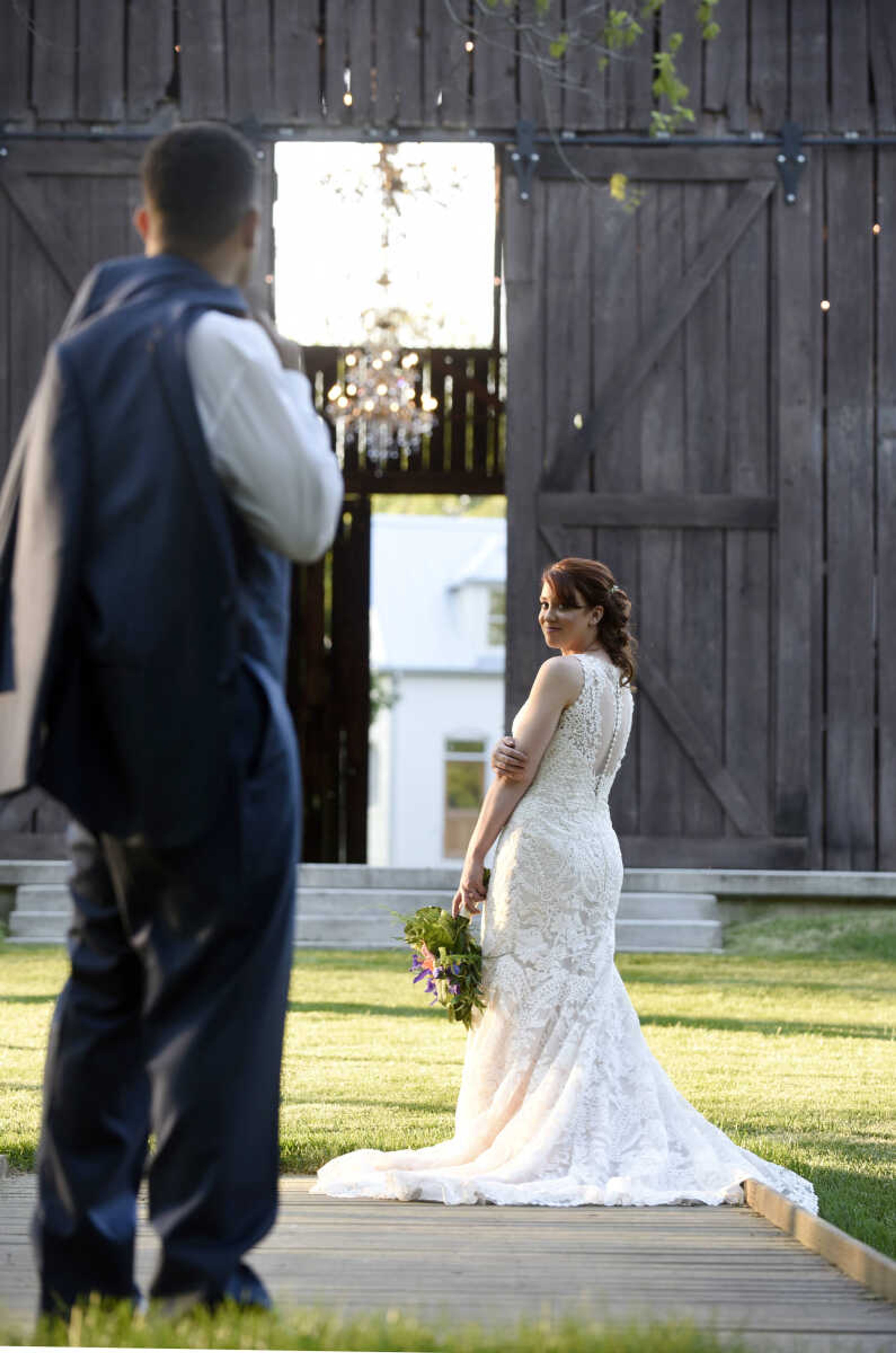 This Eddy K dress is a fit and flare, ivory on champagne colored gown. It has heavily embroidered symmetrical lace over velure tulle, with a detailed illusion back. Available at Ann-Louise Bridal in Jackson. 

Wedding suits courtesy of Jim's Formal Wear and available at Garber's Men's Wear in Cape Girardeau.