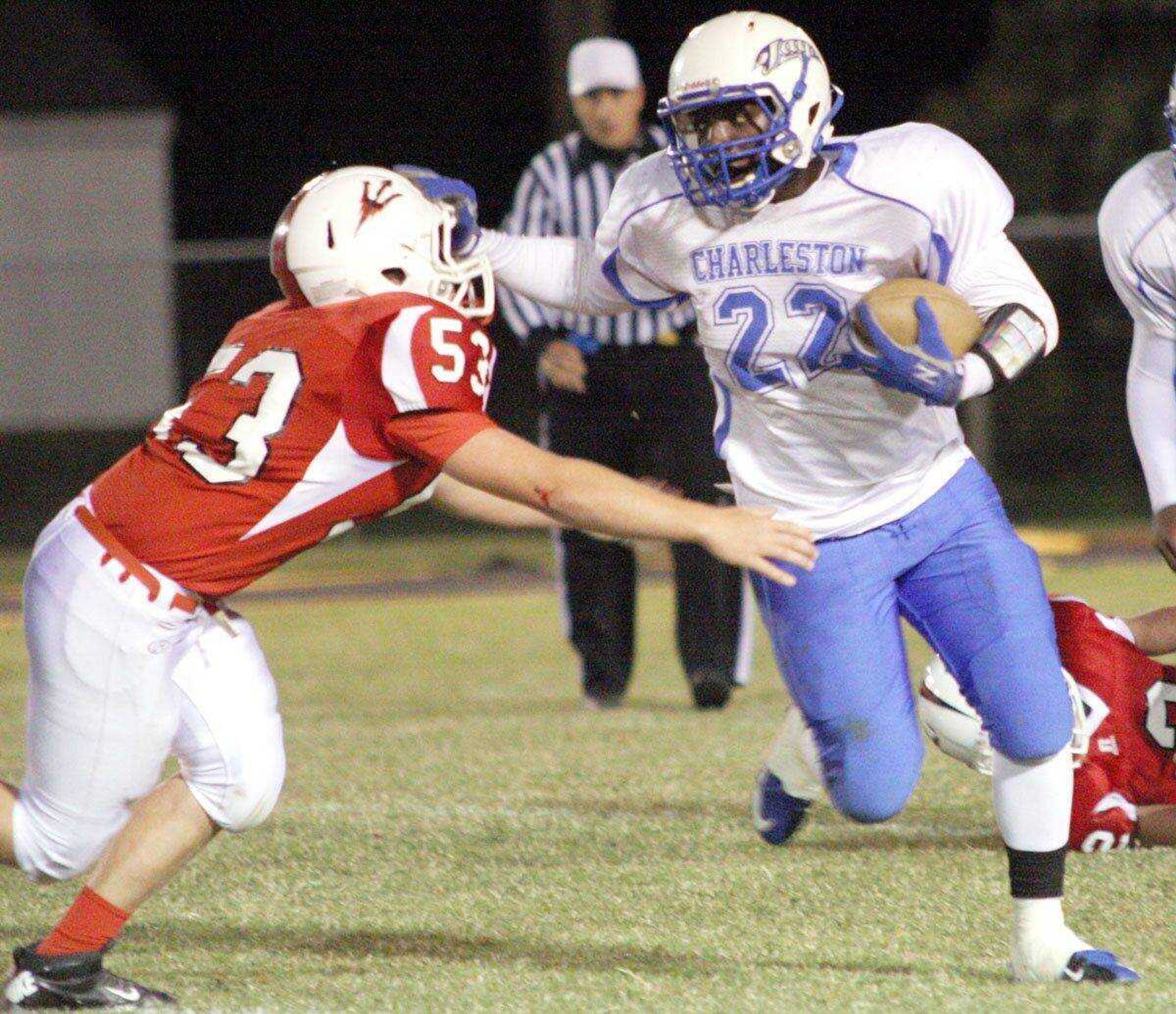 Charleston fullback Deiontrail Winston stiff arms Chaffee defender Jake Perkins Friday at Chaffee High School. (Chris Pobst ~ Standard-Democrat)