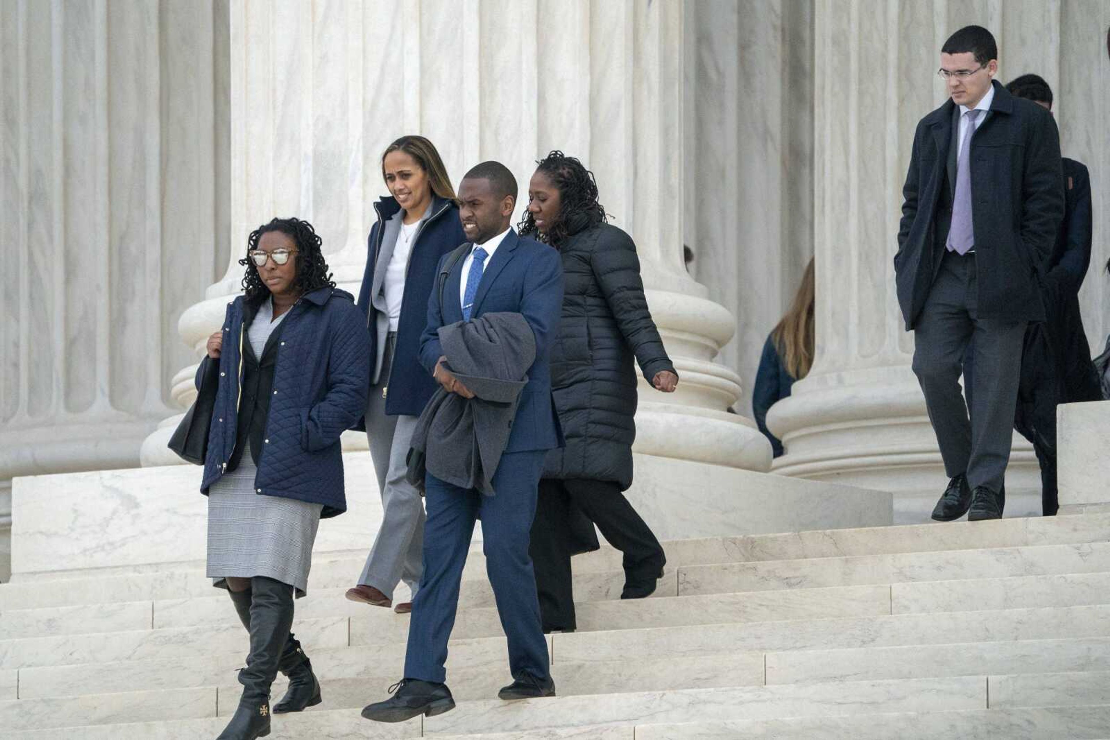 People leave the Supreme Court in Washington after arguments Wednesday challenging a Mississippi prosecutor's decision to keep African-Americans off the jury in the trial of Curtis Flowers, a black death row inmate who has been tried six times for murder.