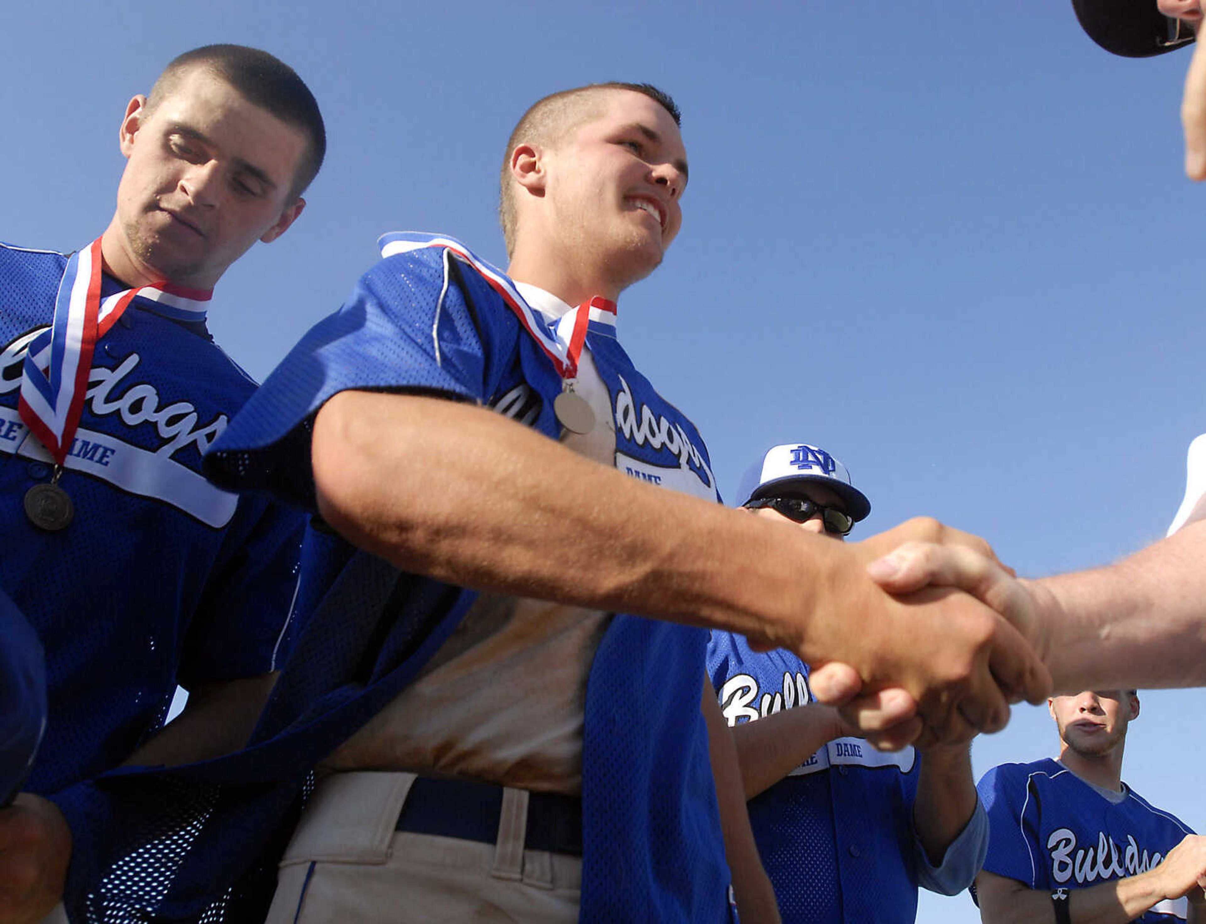 JUSTIN KELLEY photo
Notre Dame's Ryan Bass receives his first place medal after the Class 3 championship game Saturday, June, 6 2009, against Carl Junction at Meador Park in Springfield.