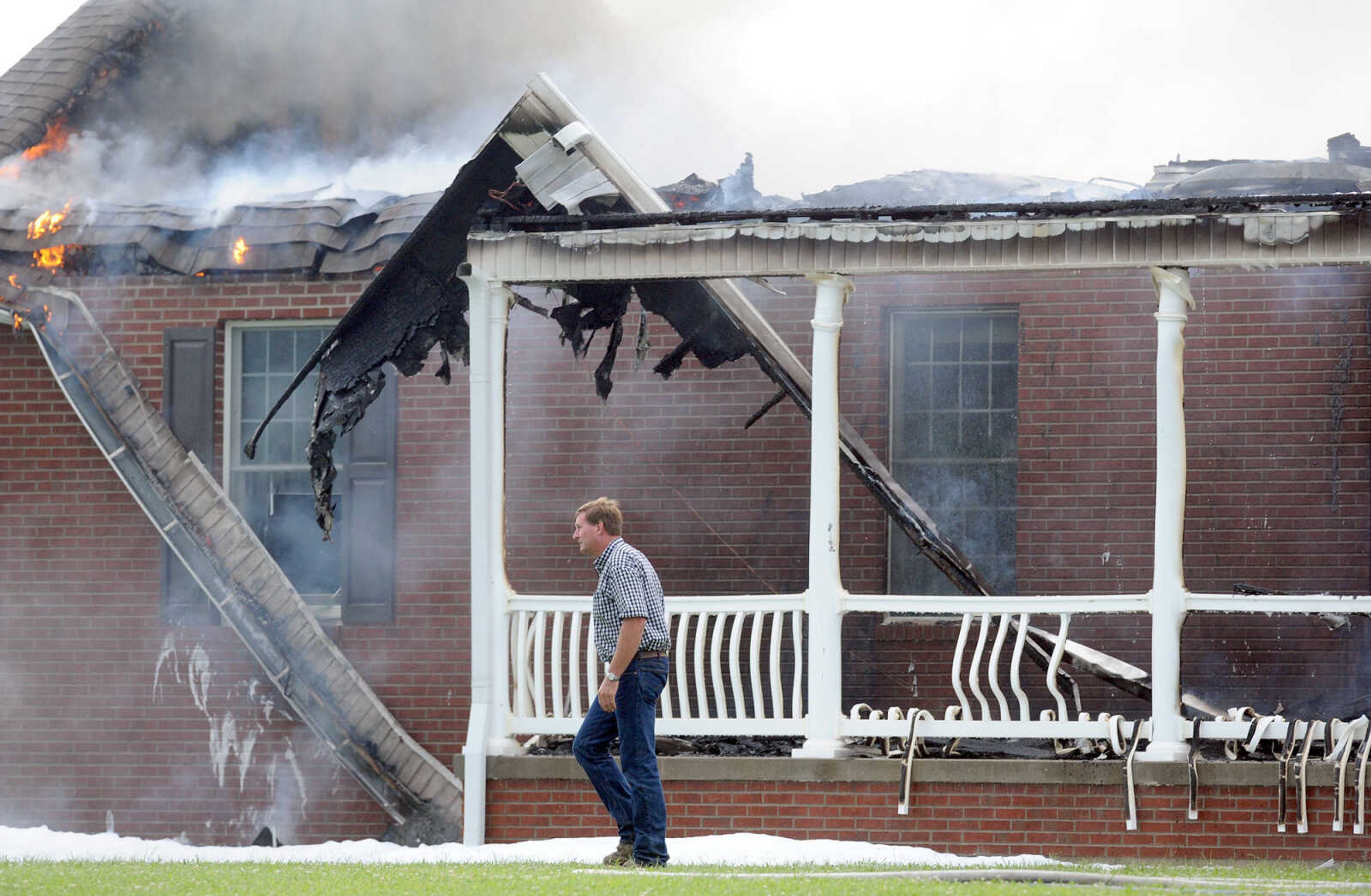 LAURA SIMON ~ lsimon@semissourian.com

David Landewee circles the perimeter of his house as firefighters from Delta, Scott City, Chaffee and New Hamburg/Benton/Commerce battle the fire engulfing his house off County Road 204 in Scott County Wednesday afternoon, July 23, 2014.