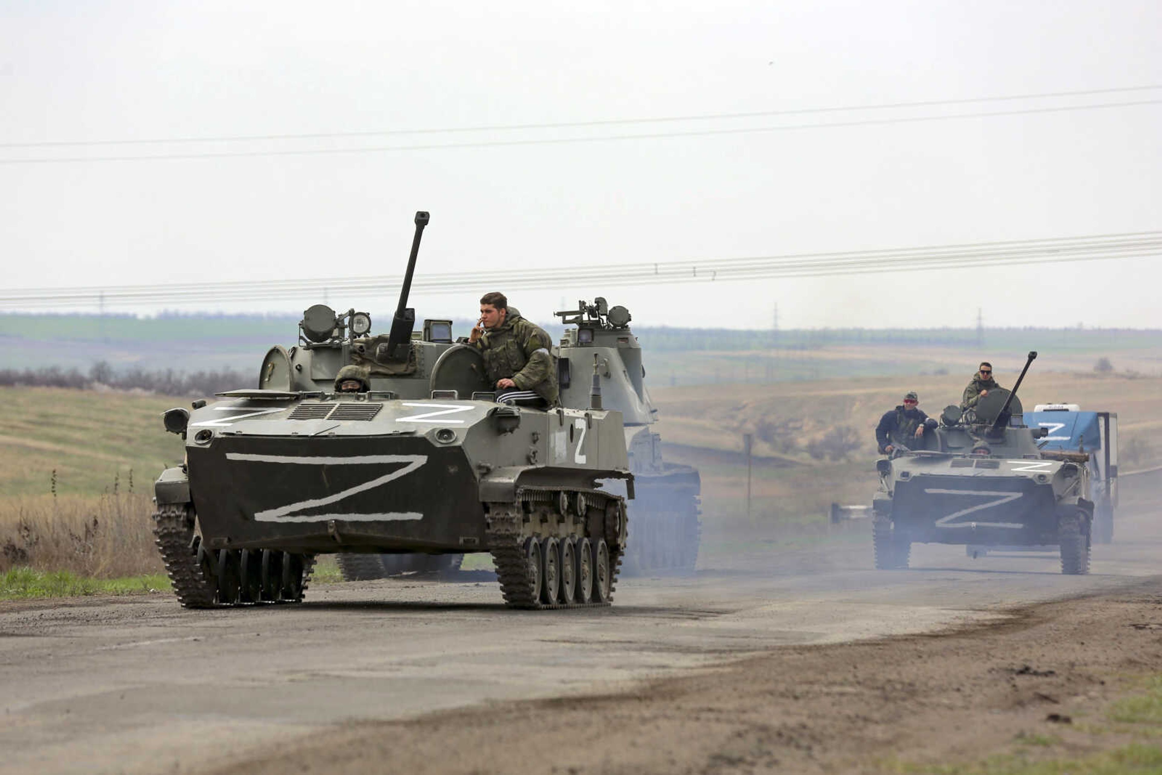 Russian military vehicles move on a highway in an area controlled by Russian-backed separatist forces Monday near Mariupol, Ukraine. Mariupol, a strategic port on the Sea of Azov, has been besieged by Russian troops and forces from self-proclaimed separatist areas in eastern Ukraine for more than six weeks.