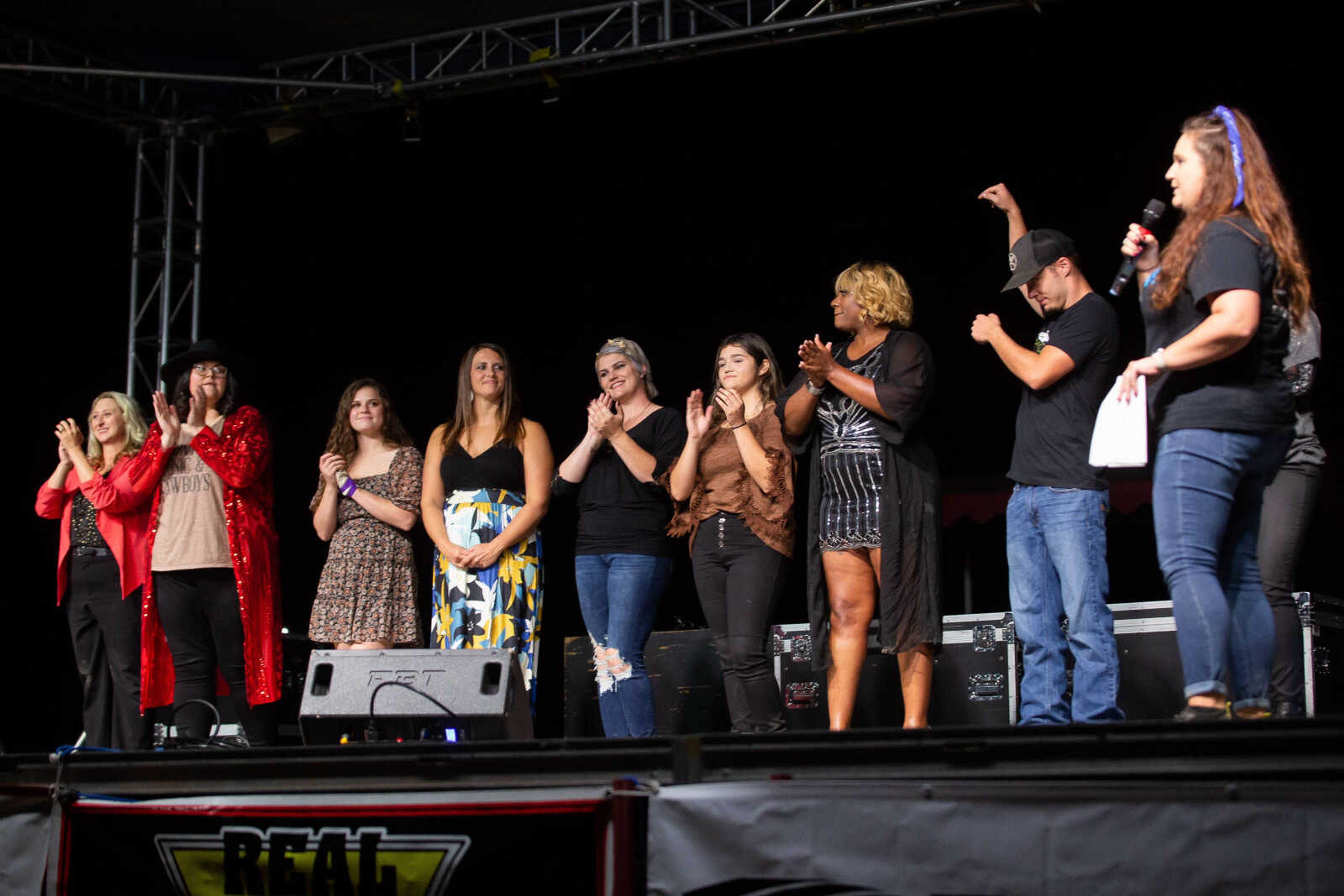 Contestants line up and clap before the winner is announced at the Heartland Idol Finals competition on Monday, Sept. 12 at the SEMO District Fair in Cape Girardeau.