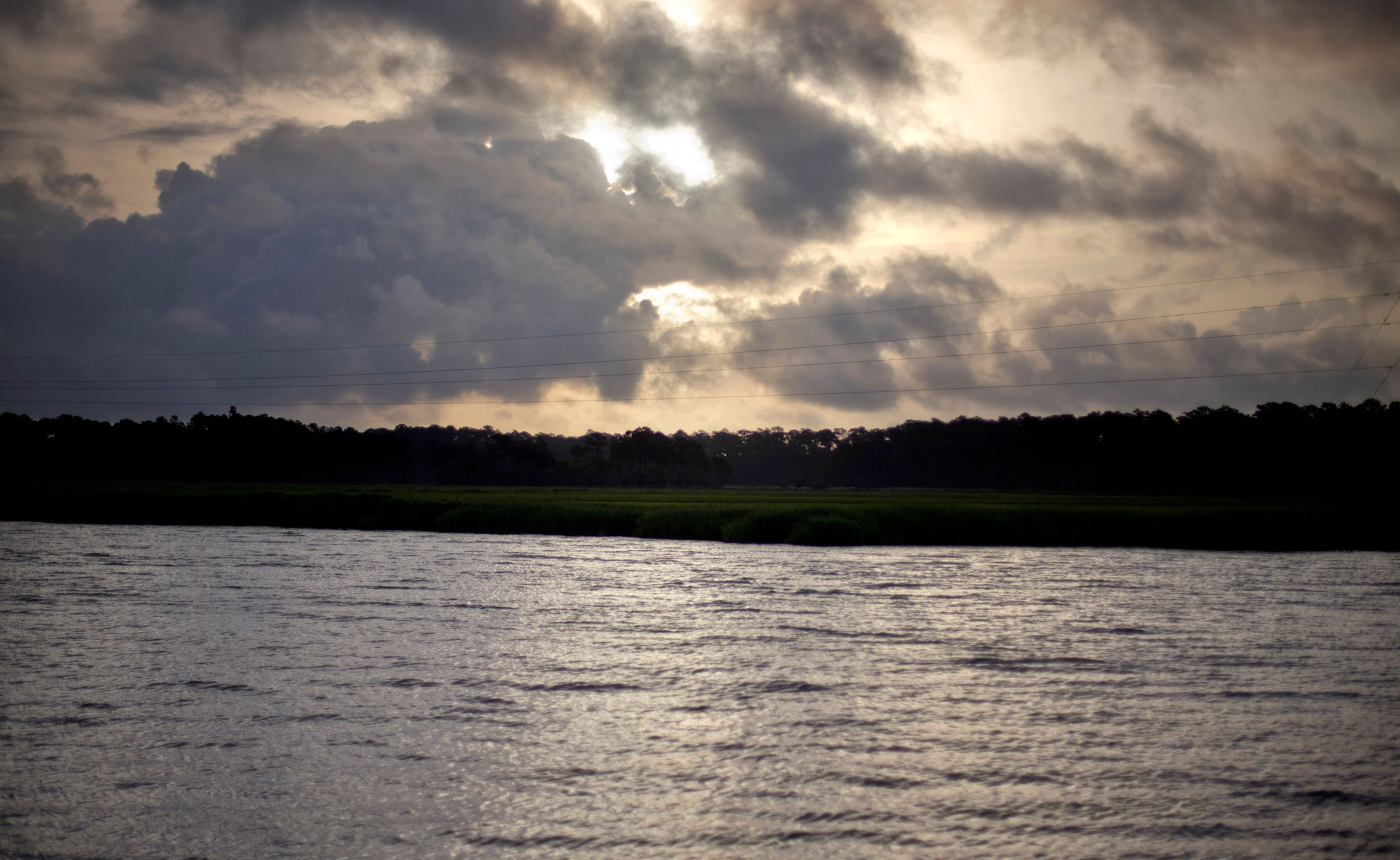 FILE - The sun rises over Sapelo Island, Ga., a Gullah-Geechee community, on June 10, 2013. (AP Photo/David Goldman, File)