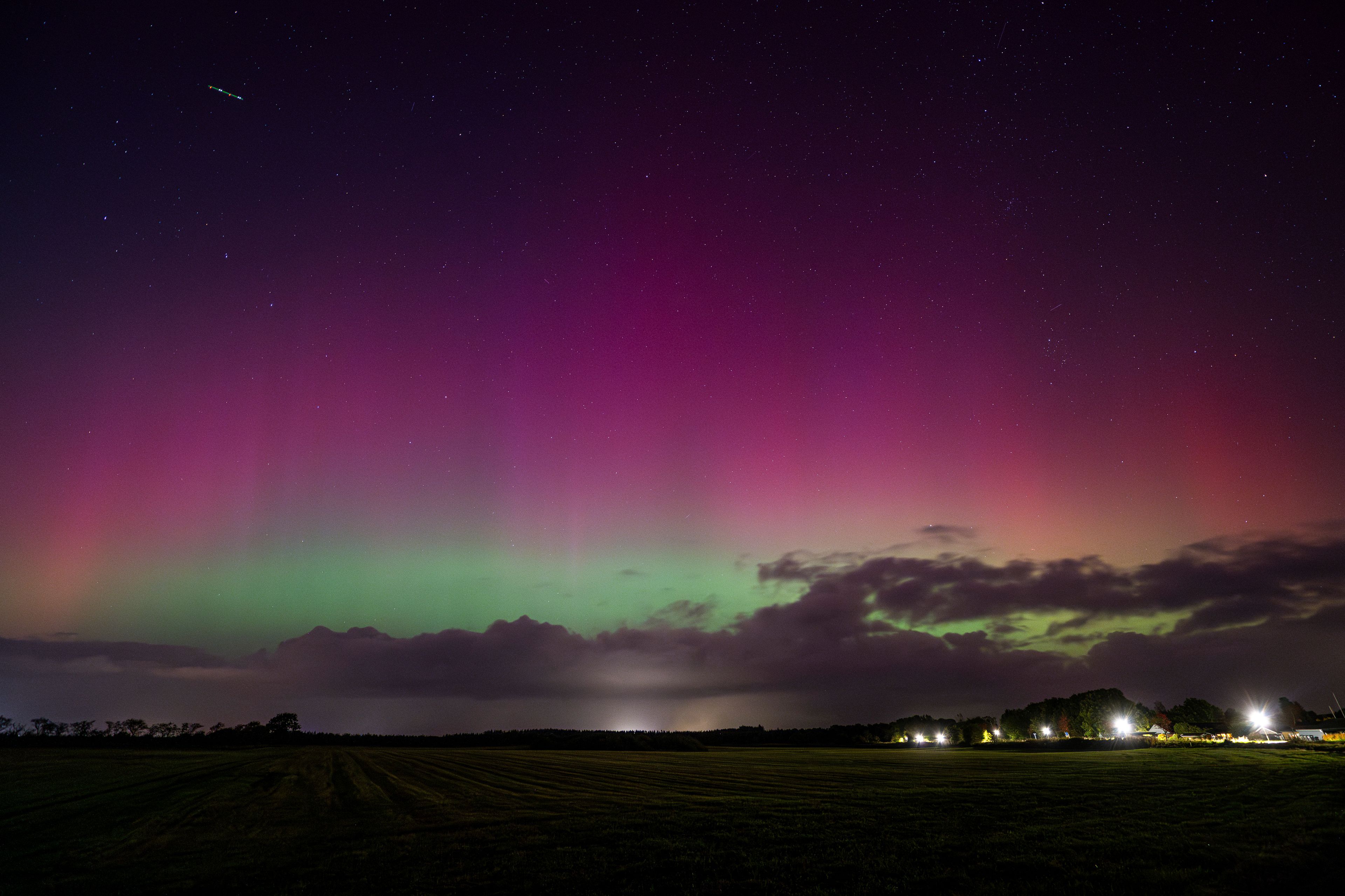 Northern lights illuminate the sky near Harrislee, Germany, Thursday, Oct. 10, 2024. (Benjamin Nolte/dpa via AP)