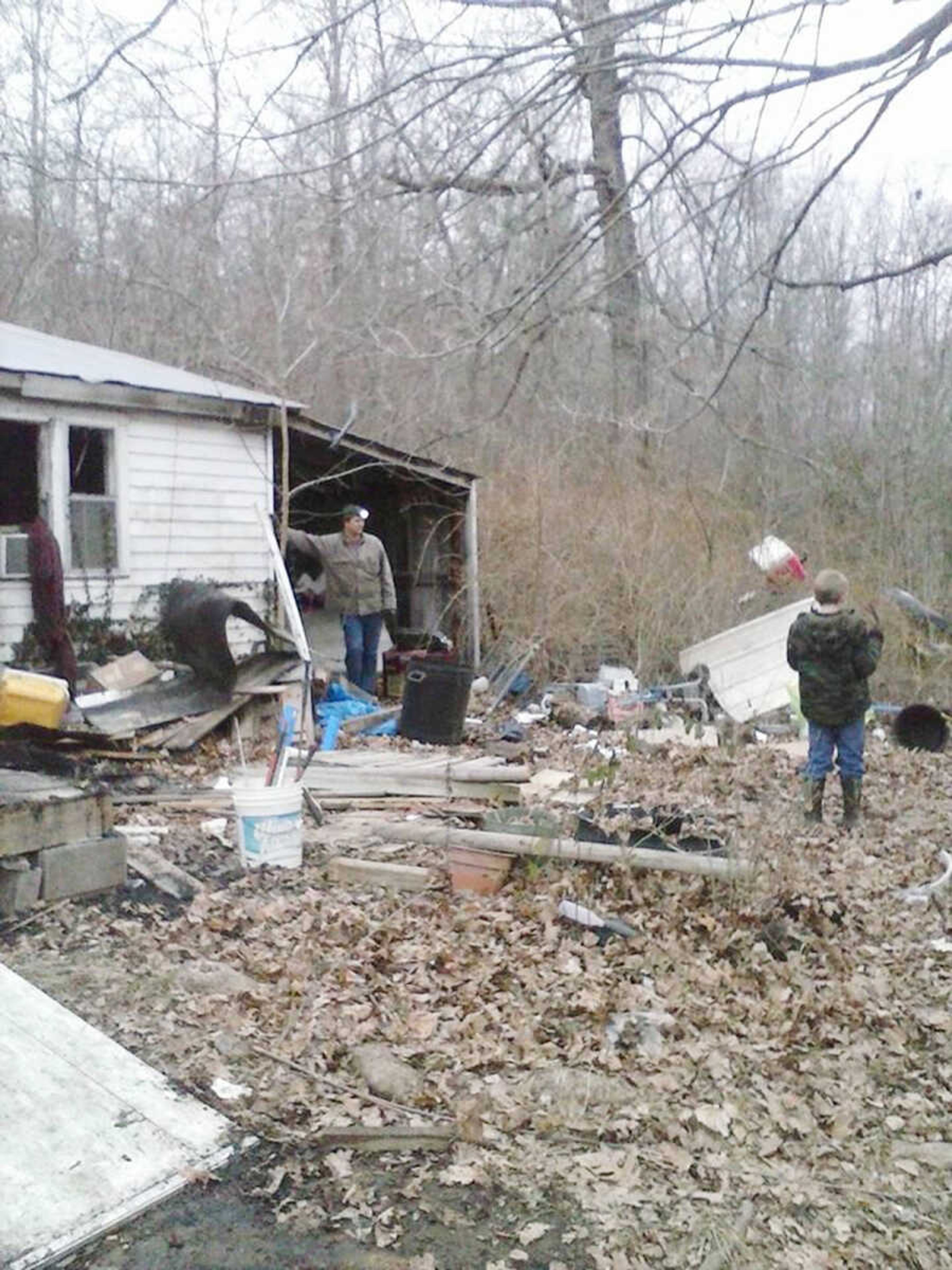 Family members of Wain and Sheila Kirkpatrick help clean up after the fire at the couple's Glen Allen home last week. (Submitted photo)