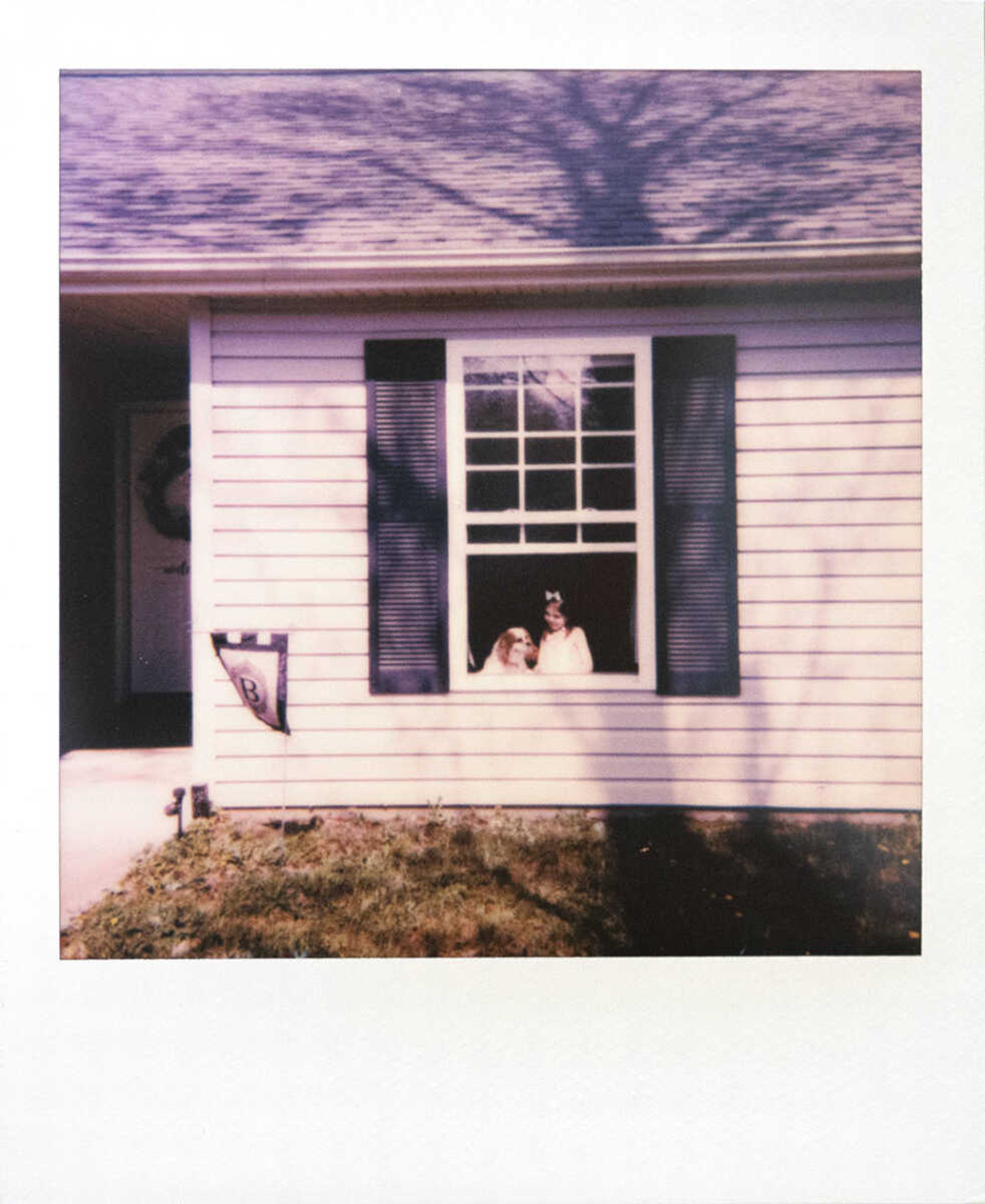 Annistyn "Anni" Bridges, 4, shares a moment with the dog, Nash, while taking a portrait Wednesday, April 8, 2020, at their Cape Girardeau home. Heather Bridges, originally of Benton, Missouri, and now Cape Girardeau, has been working full time while staying at home with her daughter Annistyn. "We have been here for the past, I think three weeks is when I started working from home," Bridges said Wednesday. "We're making it work, but definitely trying to be as organized as possible with me getting my work done and her, we're doing pre-k from home. ... It's been interesting and we're taking it a day at a time."