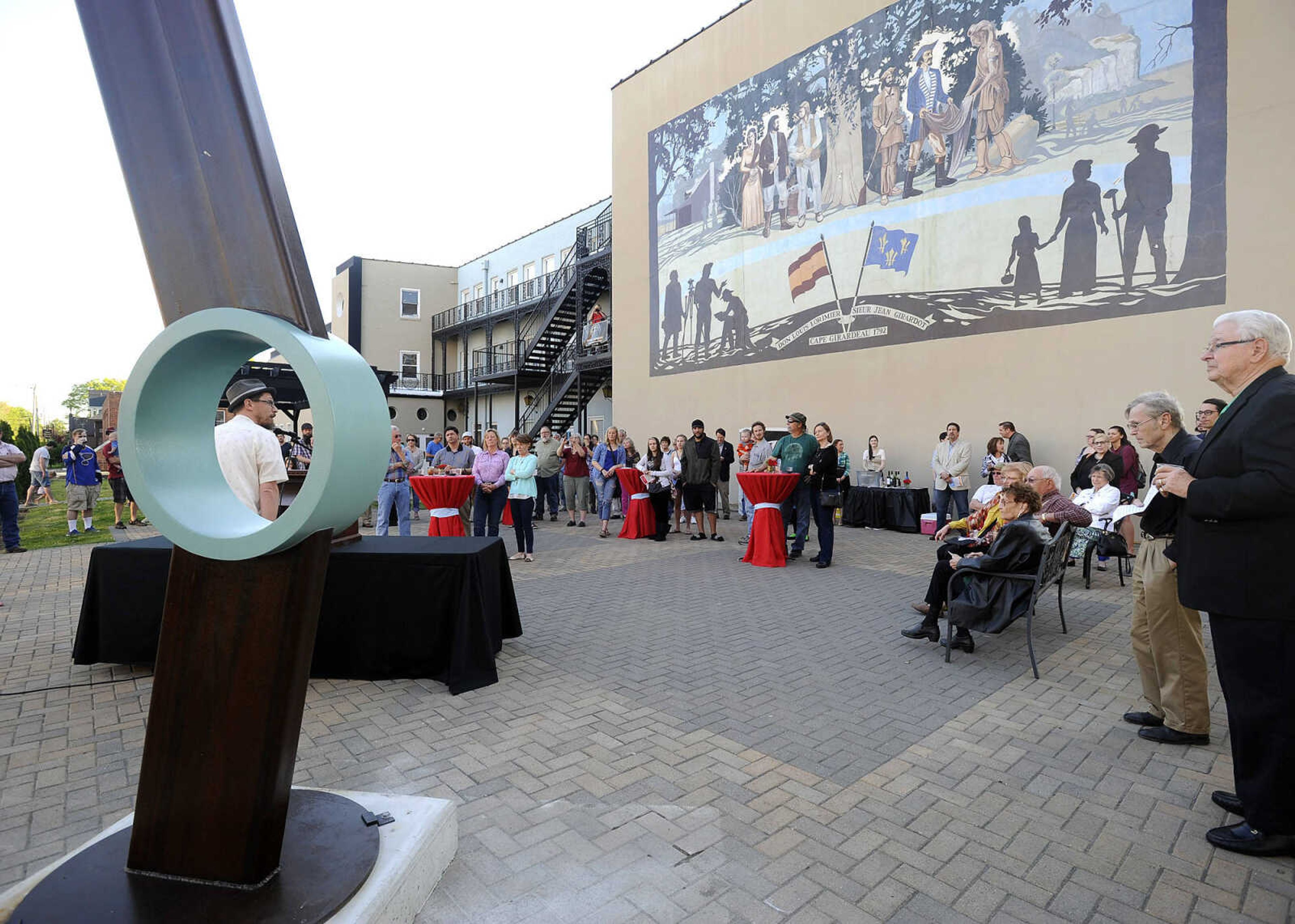 FRED LYNCH ~ flynch@semissourian.com
Chris Wubbena speaks at the opening reception for the Cape Girardeau Outdoor Sculpture Exhibit on Friday, April 15, 2016 at the Vasterling Suites Courtyard in Cape Girardeau. "Hesitant," a sculpture by Ben Pierce, is situated there.