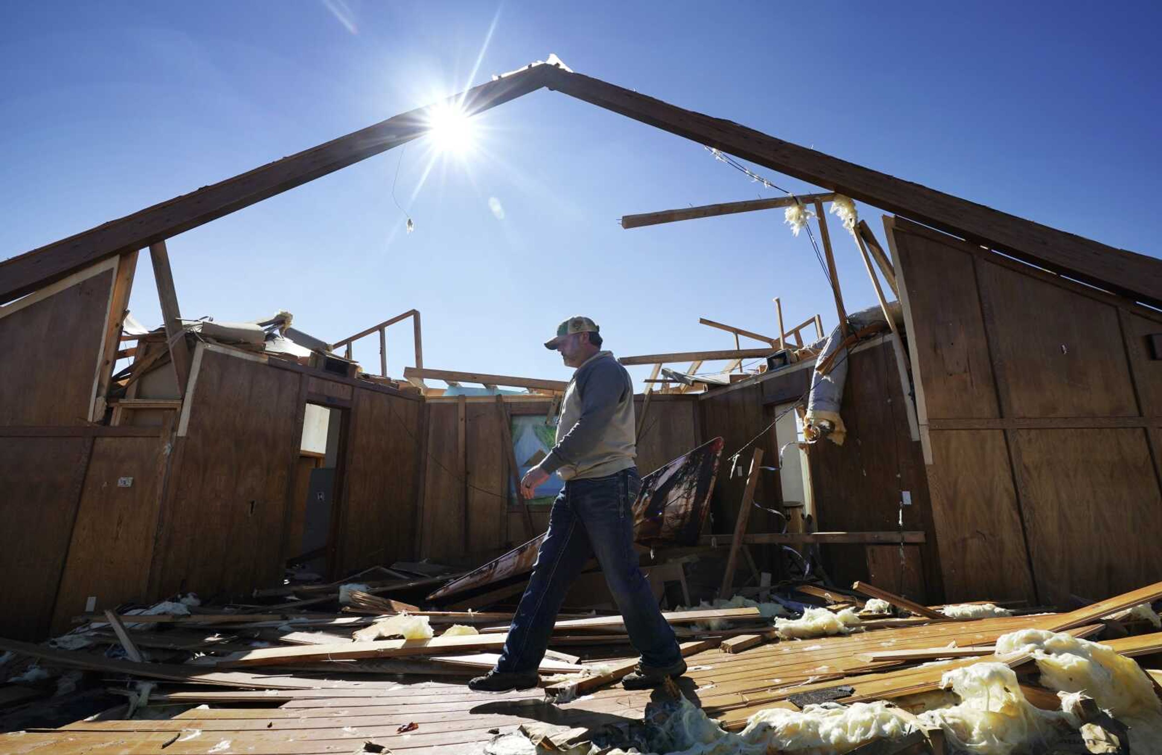 Danny Palmer, a deacon at Trinity Baptist Church, walks across the destroyed church's sanctuary Saturday, Nov. 5, while looking for items to salvage after a tornado hit Idabel, Oklahoma.