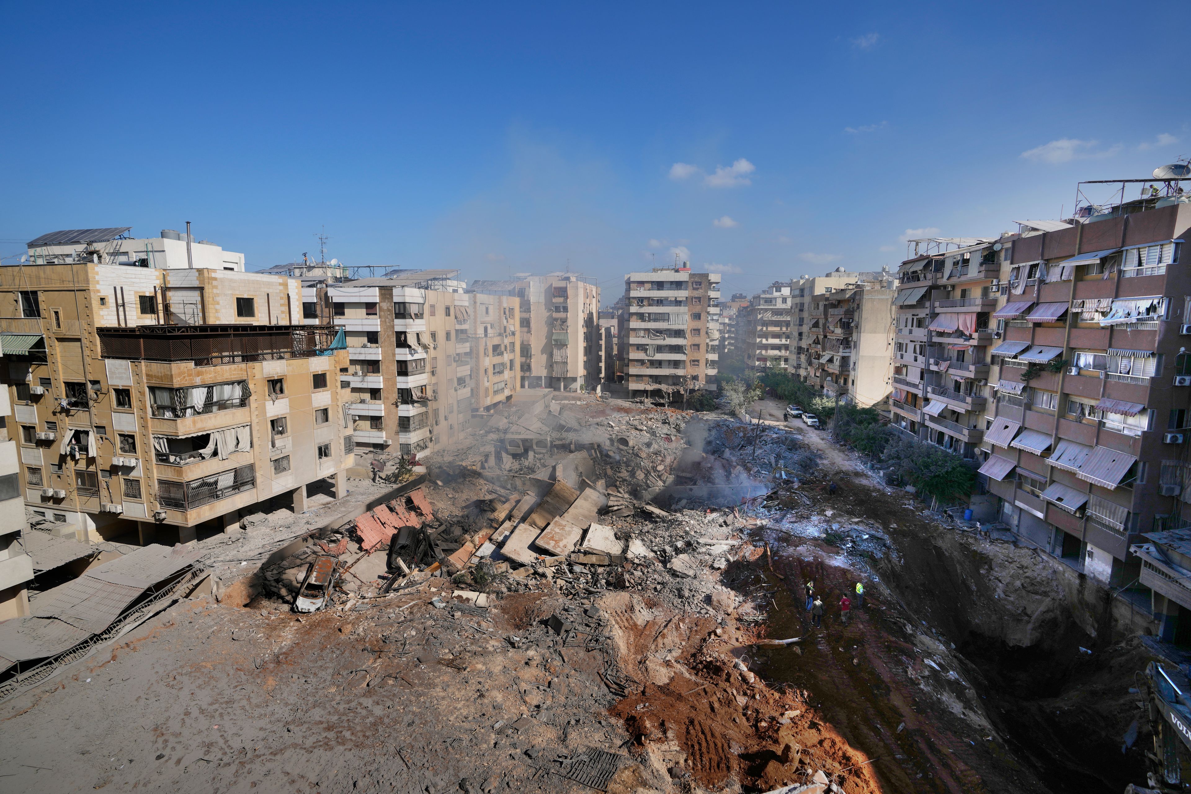 People gather at the site of the assassination of Hezbollah leader Hassan Nasrallah in Beirut's southern suburbs, Sunday, Sept. 29, 2024. (AP Photo/Hassan Ammar)