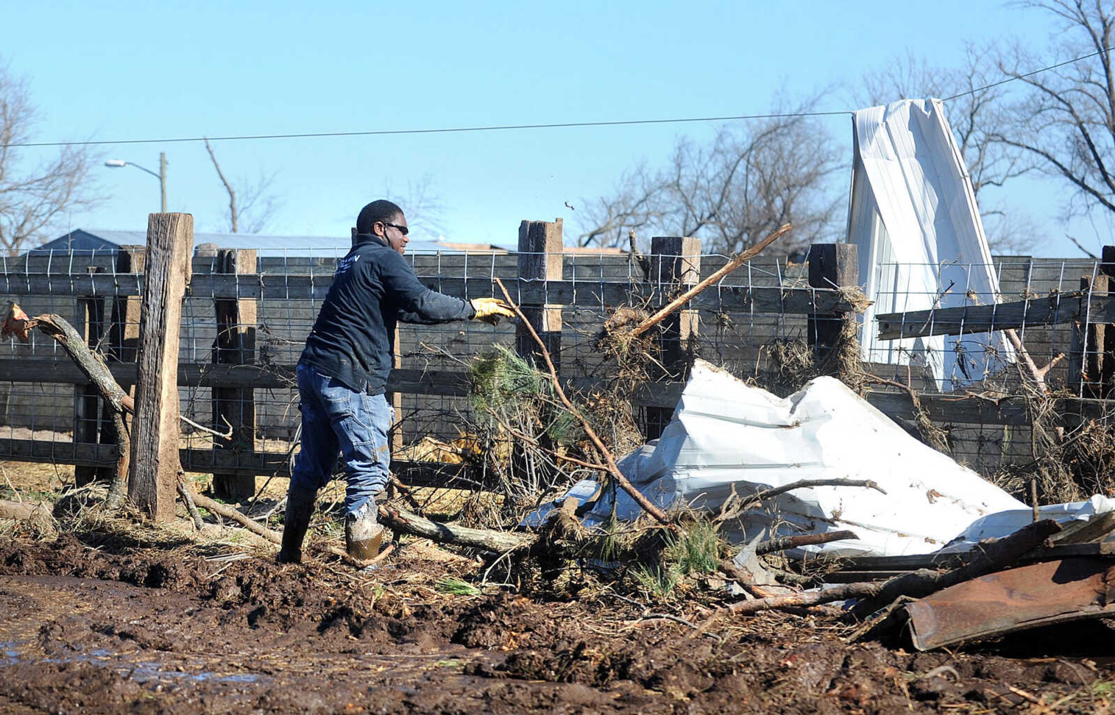 LAURA SIMON ~ lsimon@semissourian.com

Joe Green cleans up debris from Sunday's storm that hit Vince Draper's cattle farm, Monday, Nov. 18, 2013, southeast of Morley, Mo.