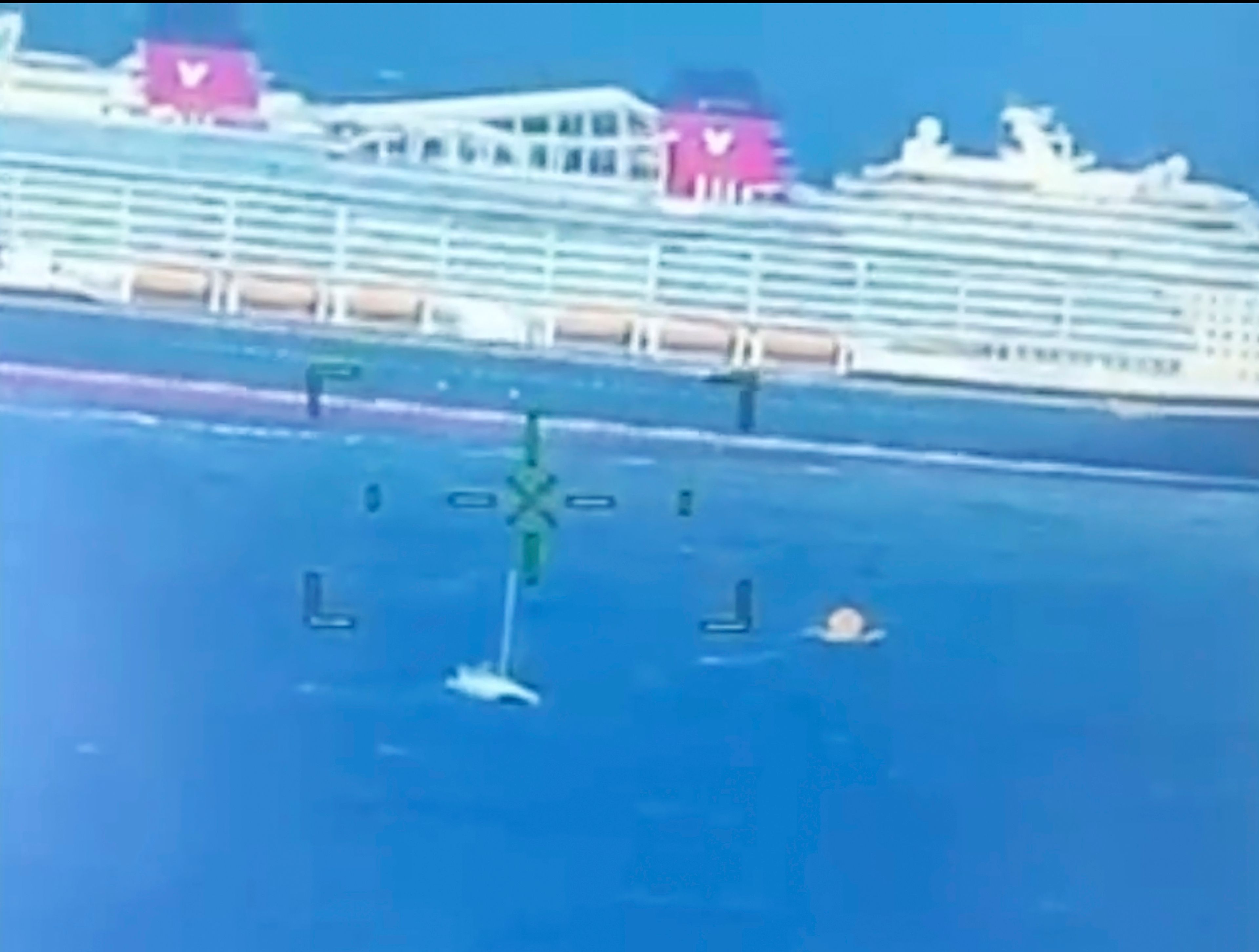 This image provided by the U.S. Coast Guard shows a cruise ship rescuing people from a disabled catamaran that was taking on water hundreds of miles off the coast of Bermuda on Nov. 10, 2024. (U.S. Coast Guard via AP)