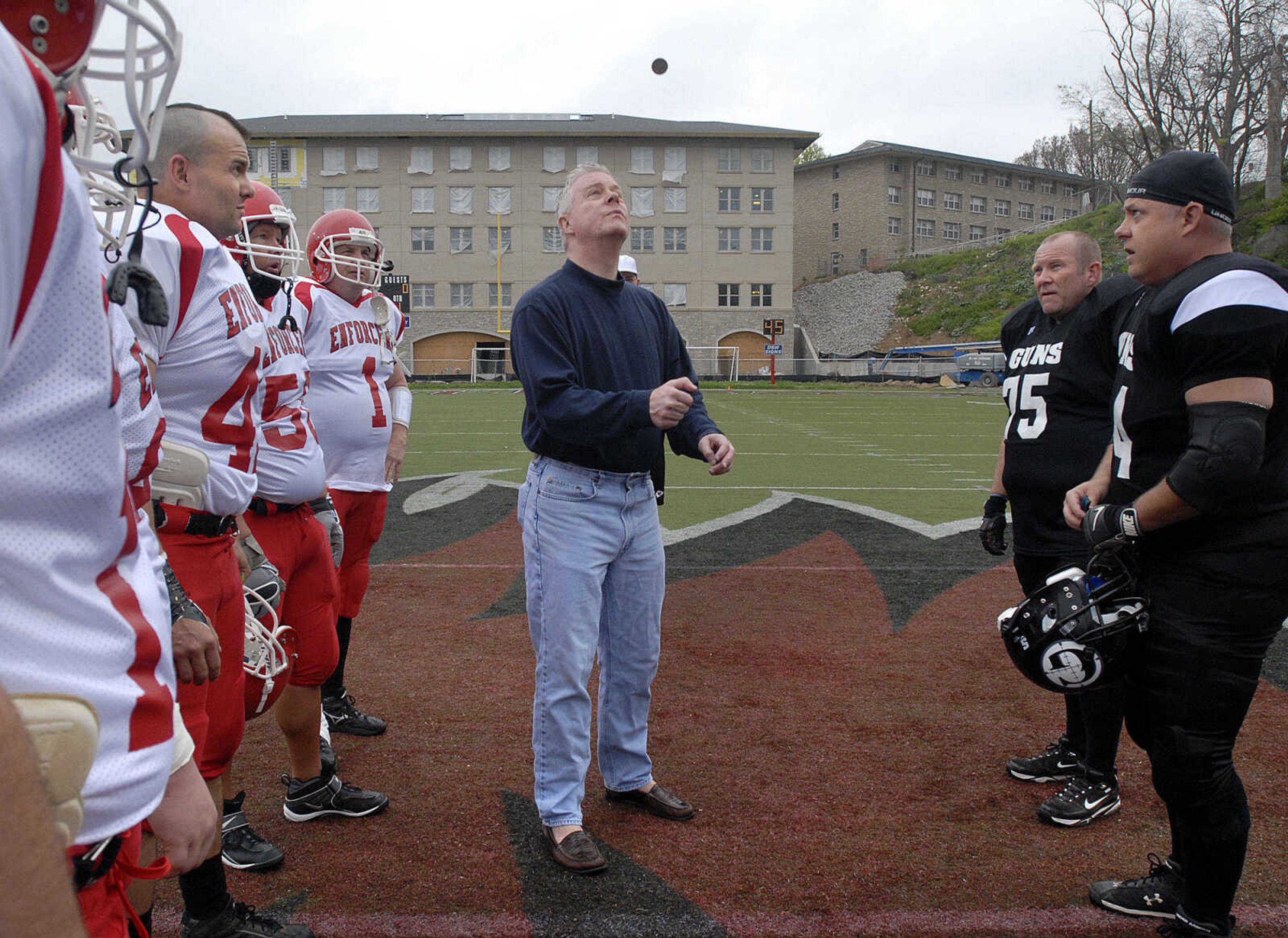 Lt. Gov. Peter Kinder tosses the coin which the Springfield Guns called and chose to defer in the benefit game with the Cape County Enforcers Saturday at Houck Stadium.