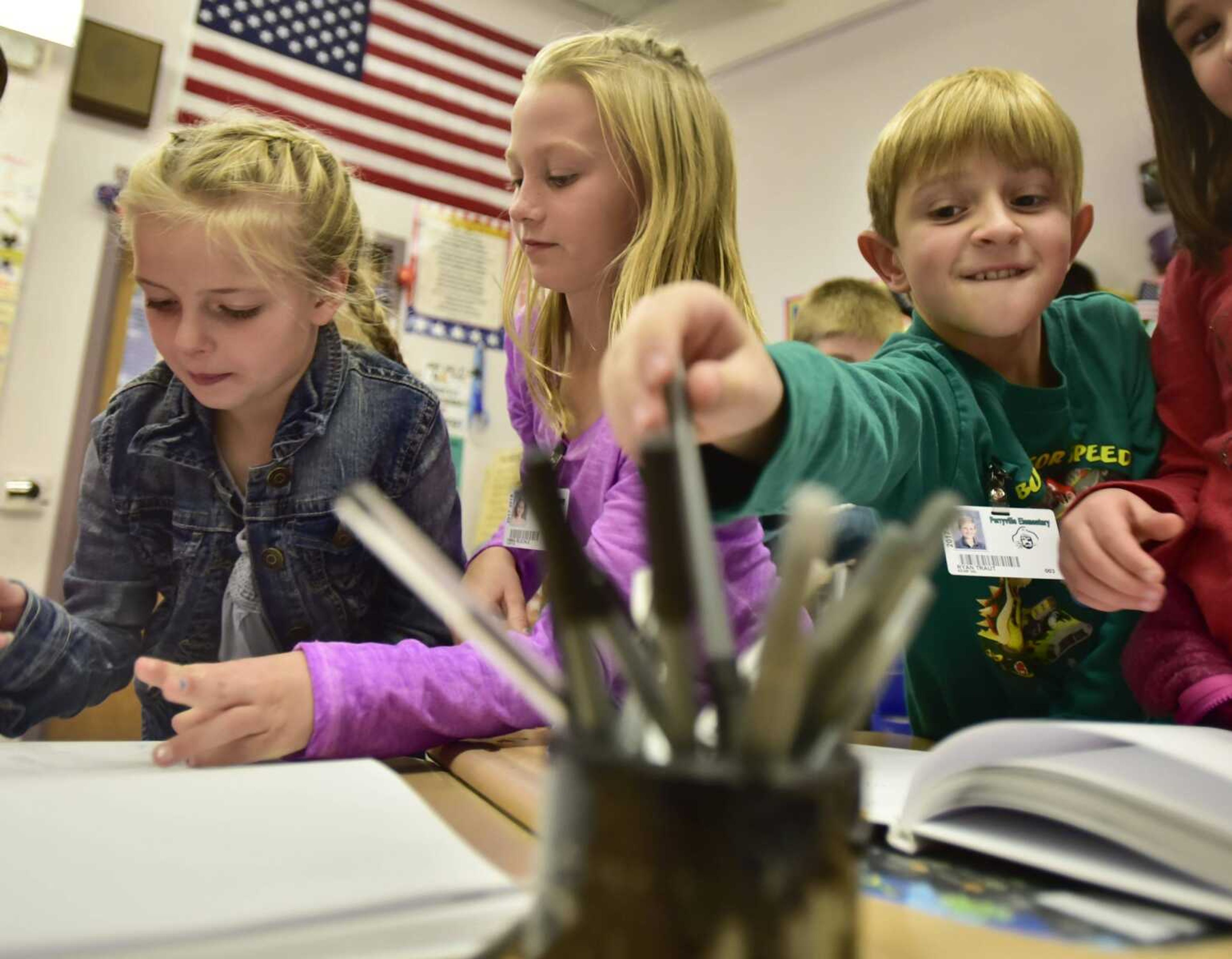 Students take turns signing copies of "Turkey's Disguise" on Tuesday at Perryville Elementary School in Perryville, Missouri.