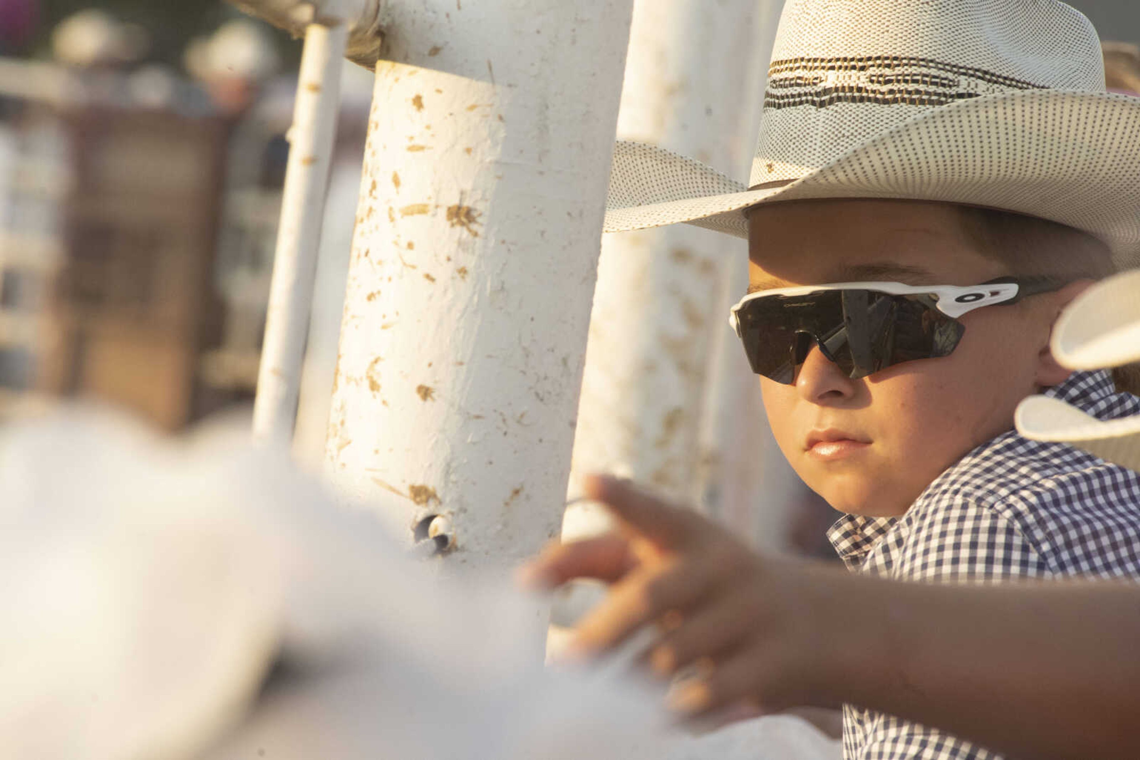 A young spectator watches the chutes during the last night of the Sikeston Jaycee Bootheel Rodeo Saturday, Aug. 14, 2021,&nbsp;in Sikeston, Missouri.