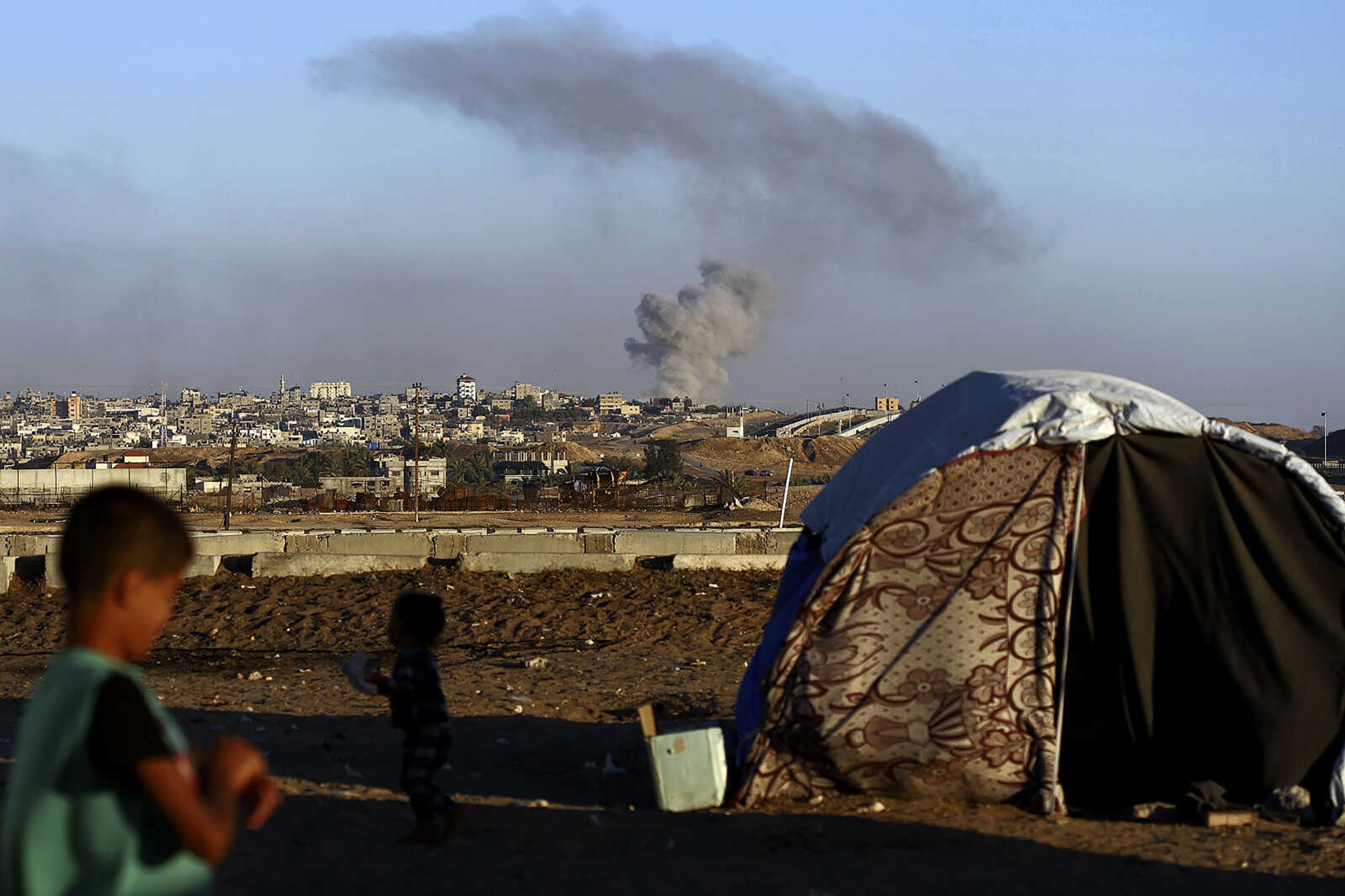 Smoke rises following an Israeli airstrike on buildings near the separating wall between Egypt and Rafah, southern Gaza Strip, Tuesday, May 7, 2024. (AP Photo/Ramez Habboub)