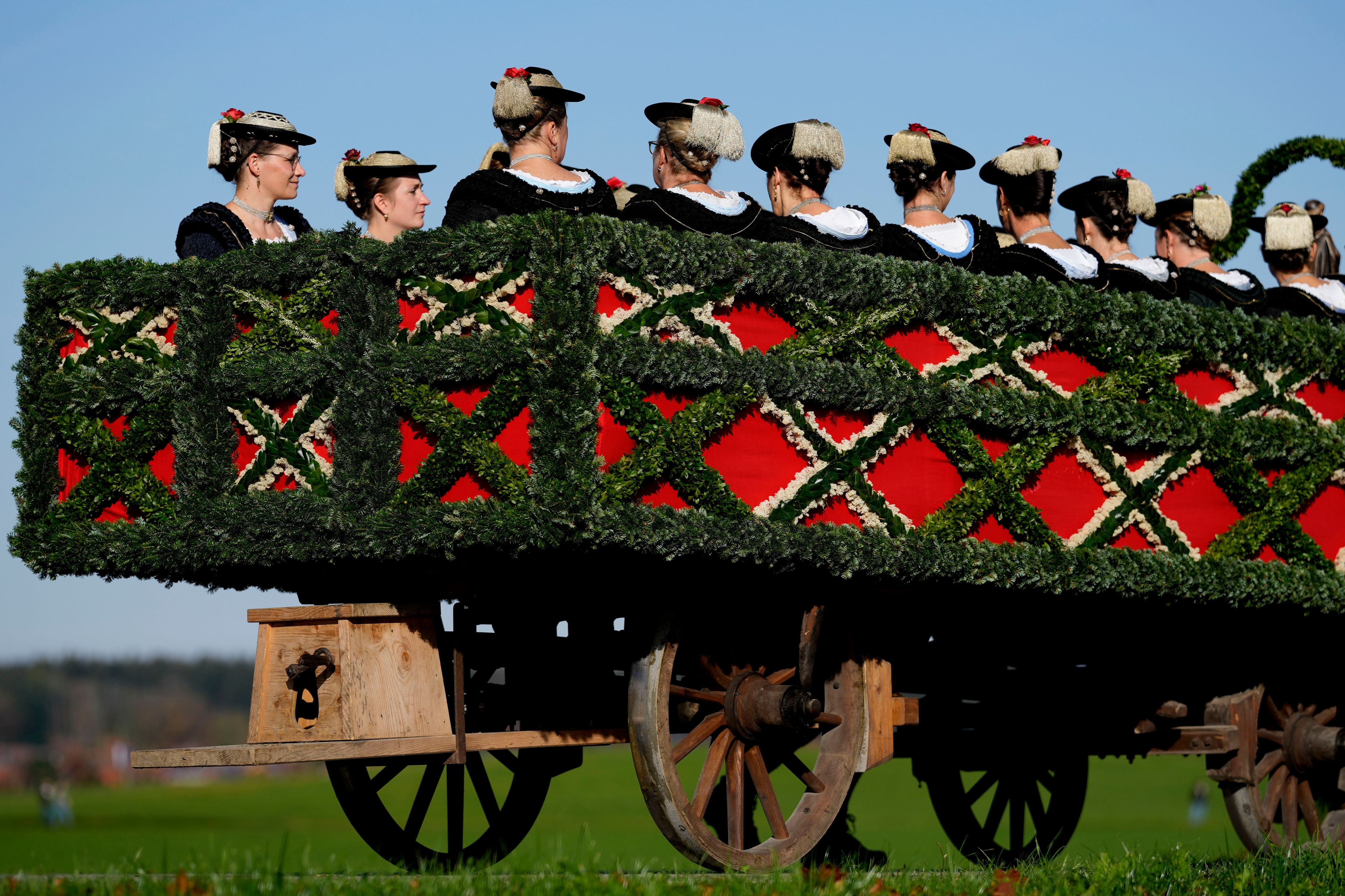 Women in traditional costumes of the region take part at the traditional Leonhardi pilgrimage in Warngau near Munich, Germany, Sunday, Oct. 27, 2024. (AP Photo/Matthias Schrader)